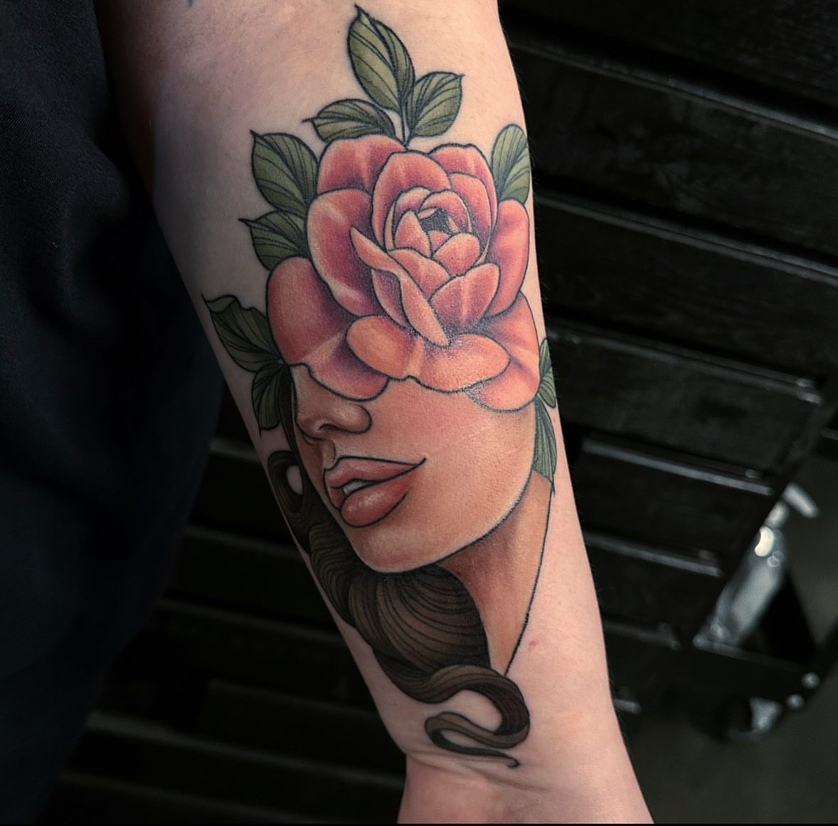 Woman with rose American traditional tattoo on the forearm by audi