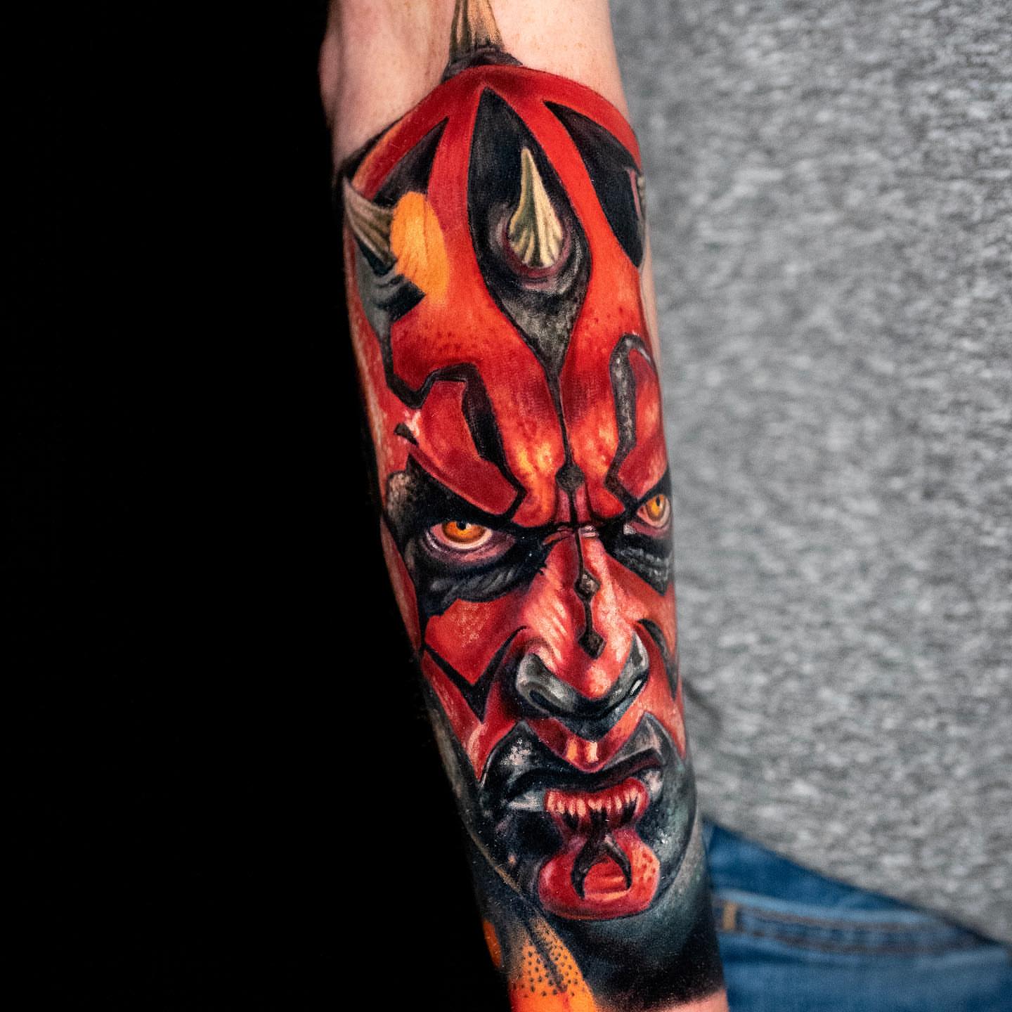 Demon face dark realism tattoo on the forearm by Alonzo Villa Tattoo