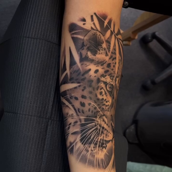 Leopard with bamboo realism tattoo by Bradley Dozier