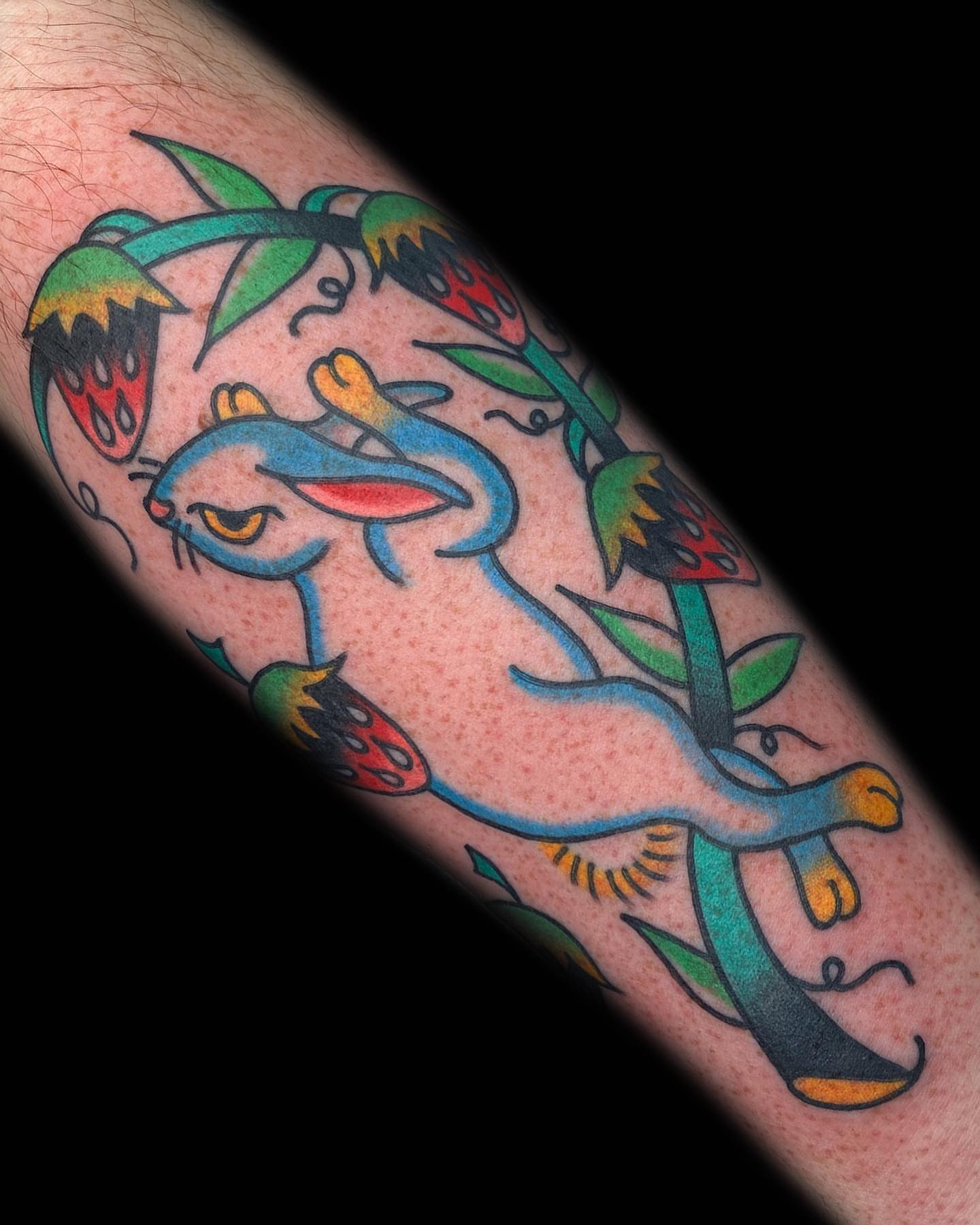 Rabbit and strawberries American traditional tattoo on the forearm by The Calamari Kid