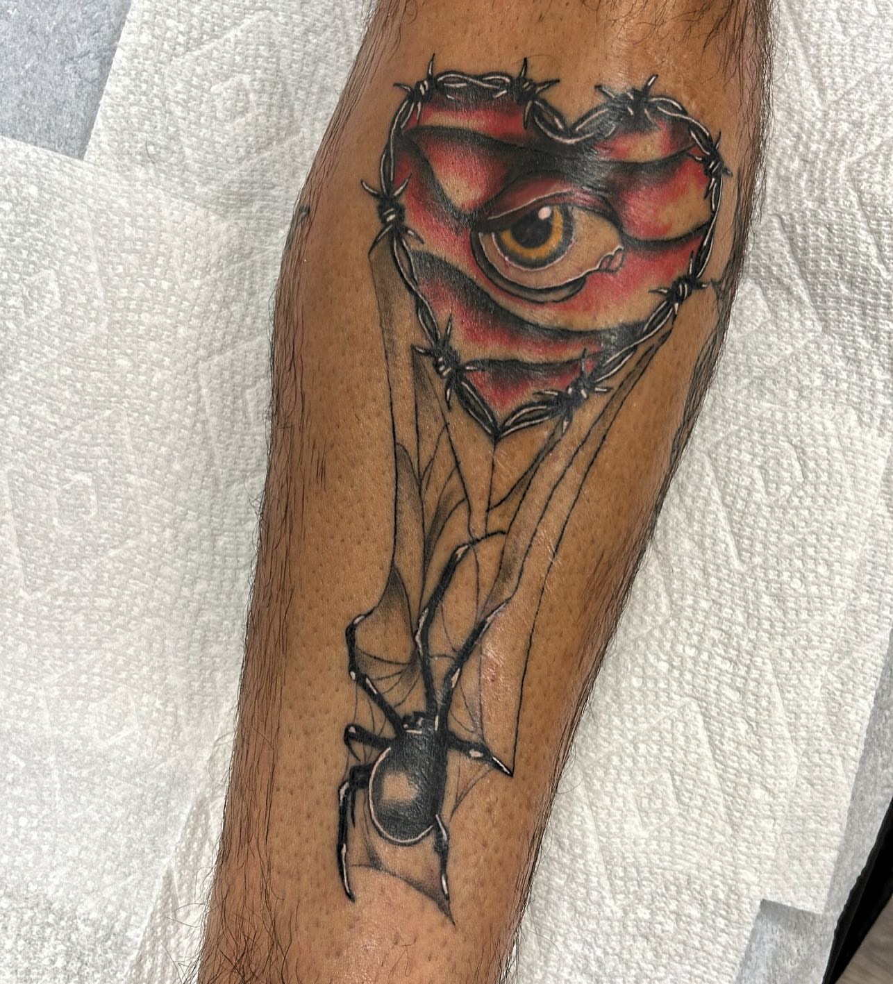 Barbed wire heart dark realism tattoo on the forearm by Edward A. Boesch