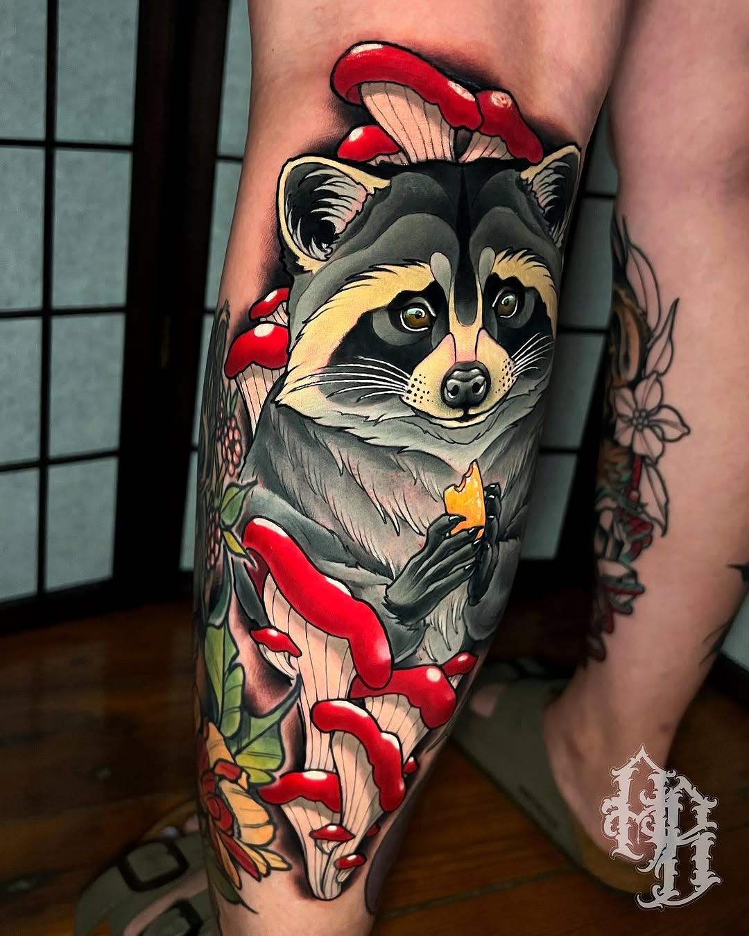 Raccoon with mushrooms American traditional tattoo on the forearm by Austin Britt