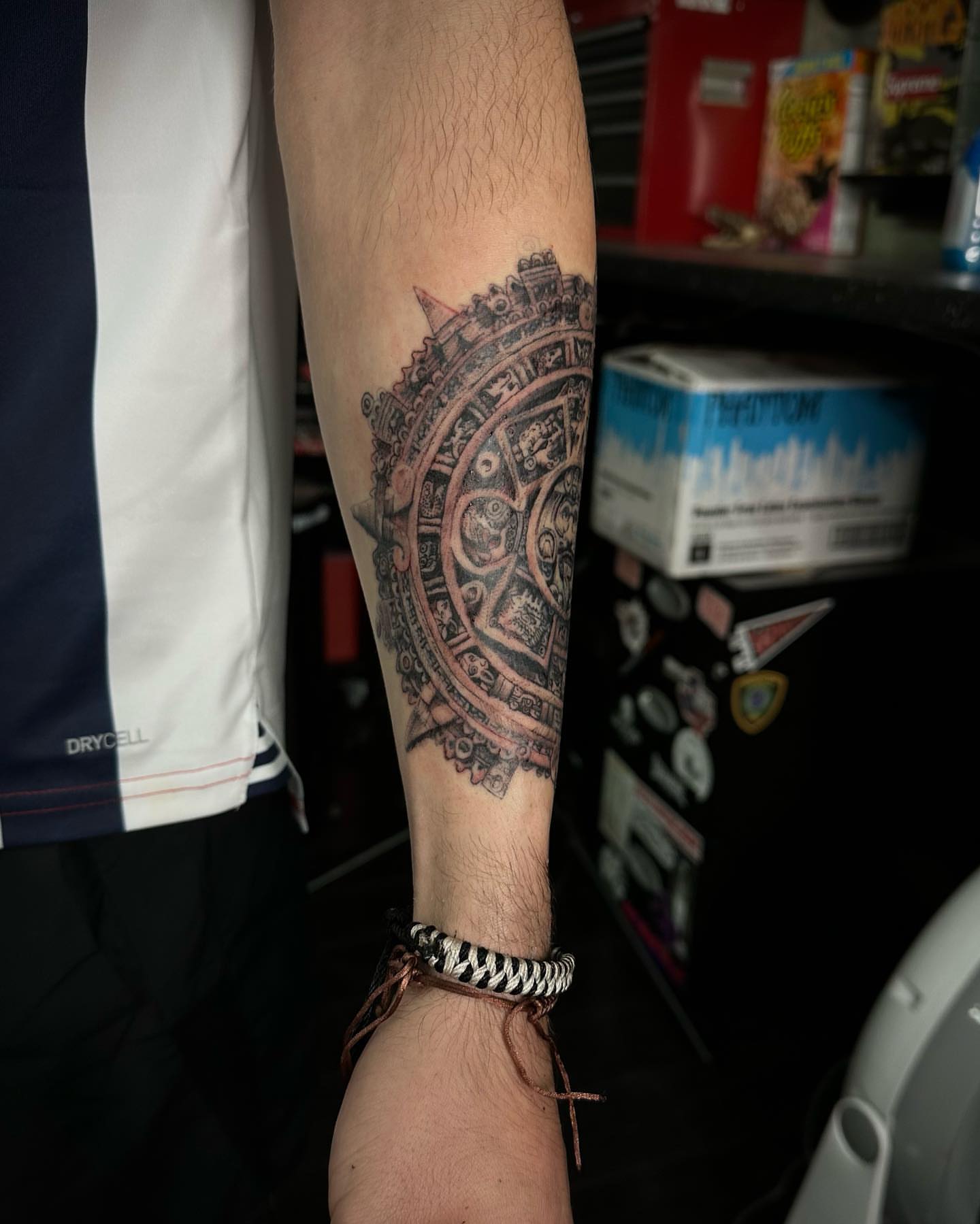 Aztec calendar geometric tattoo on the forearm by Leo Torres