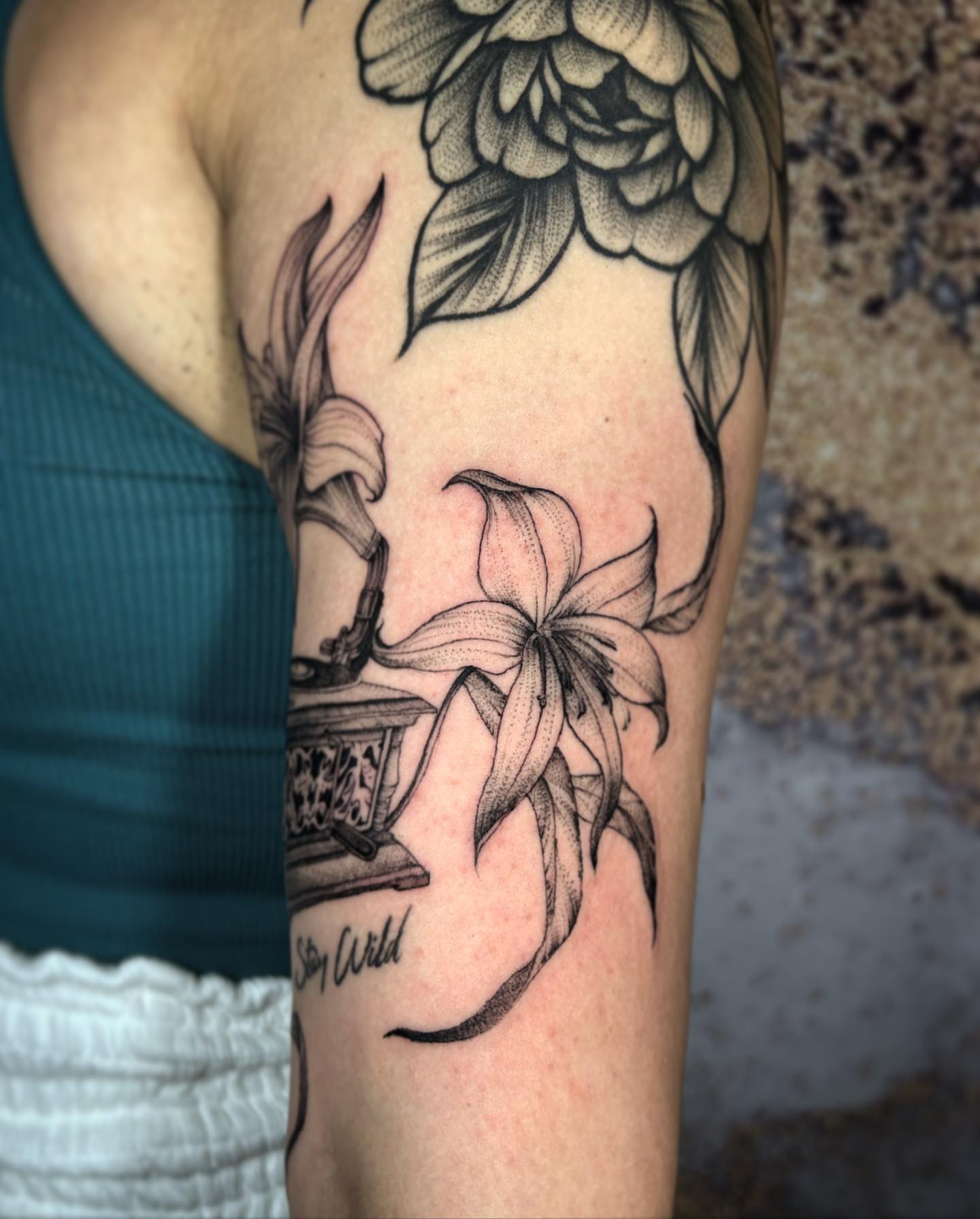 Lilies and floral arrangement realism tattoo on the forearm by Cindy Xu