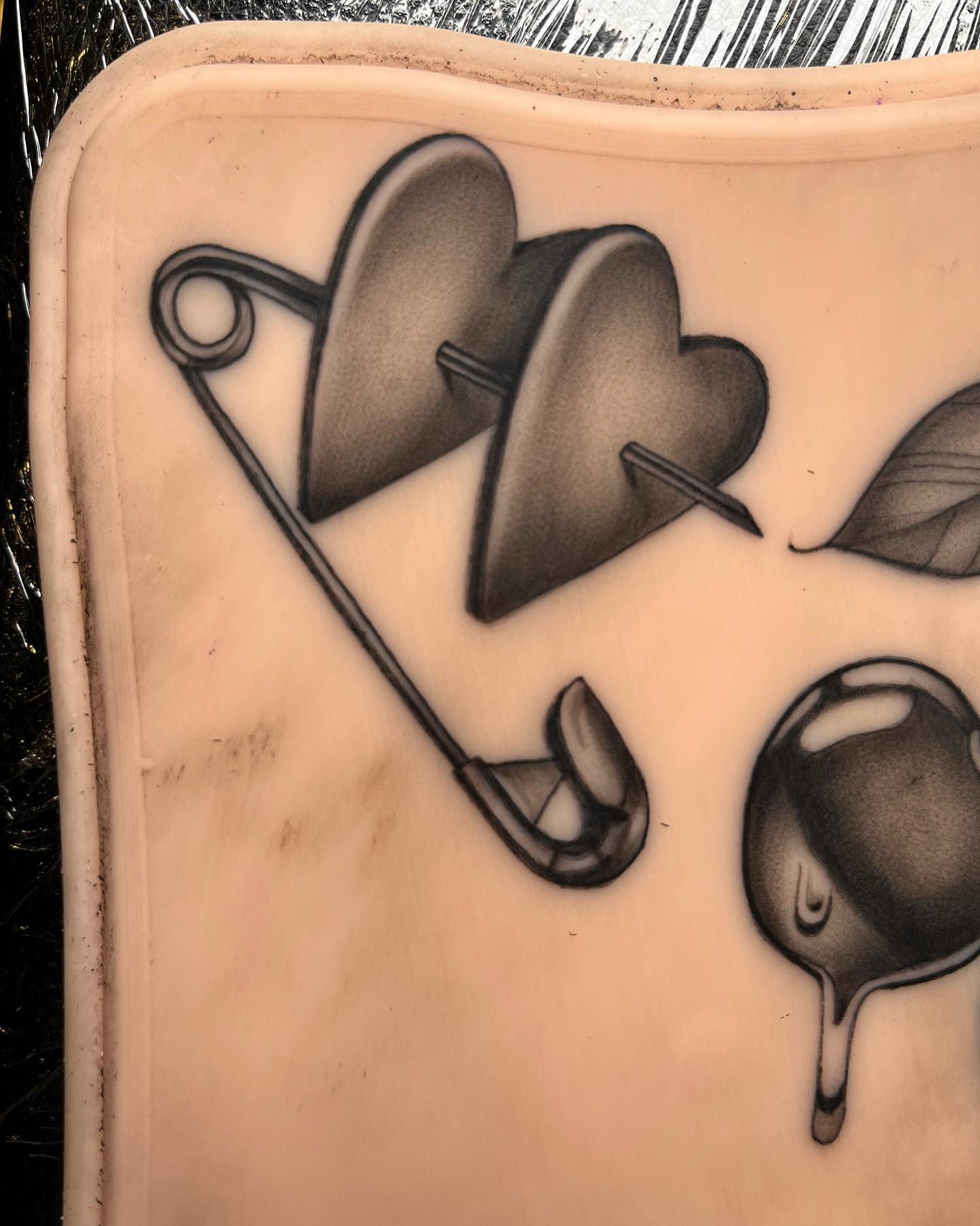 Heart and safety pin black and grey tattoo by Anthony “Jiinky” Quintanilla 🧸☁️