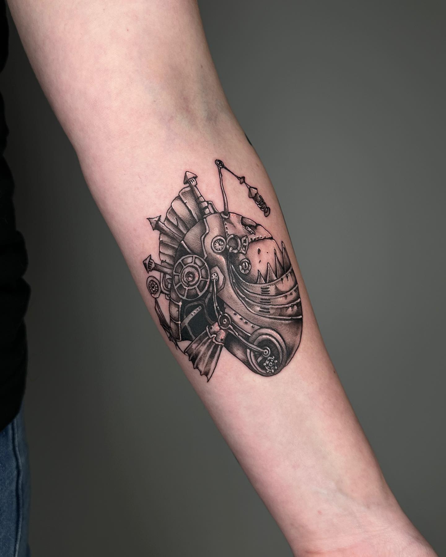 Mechanical vehicle black and grey tattoo on the forearm by A L e X