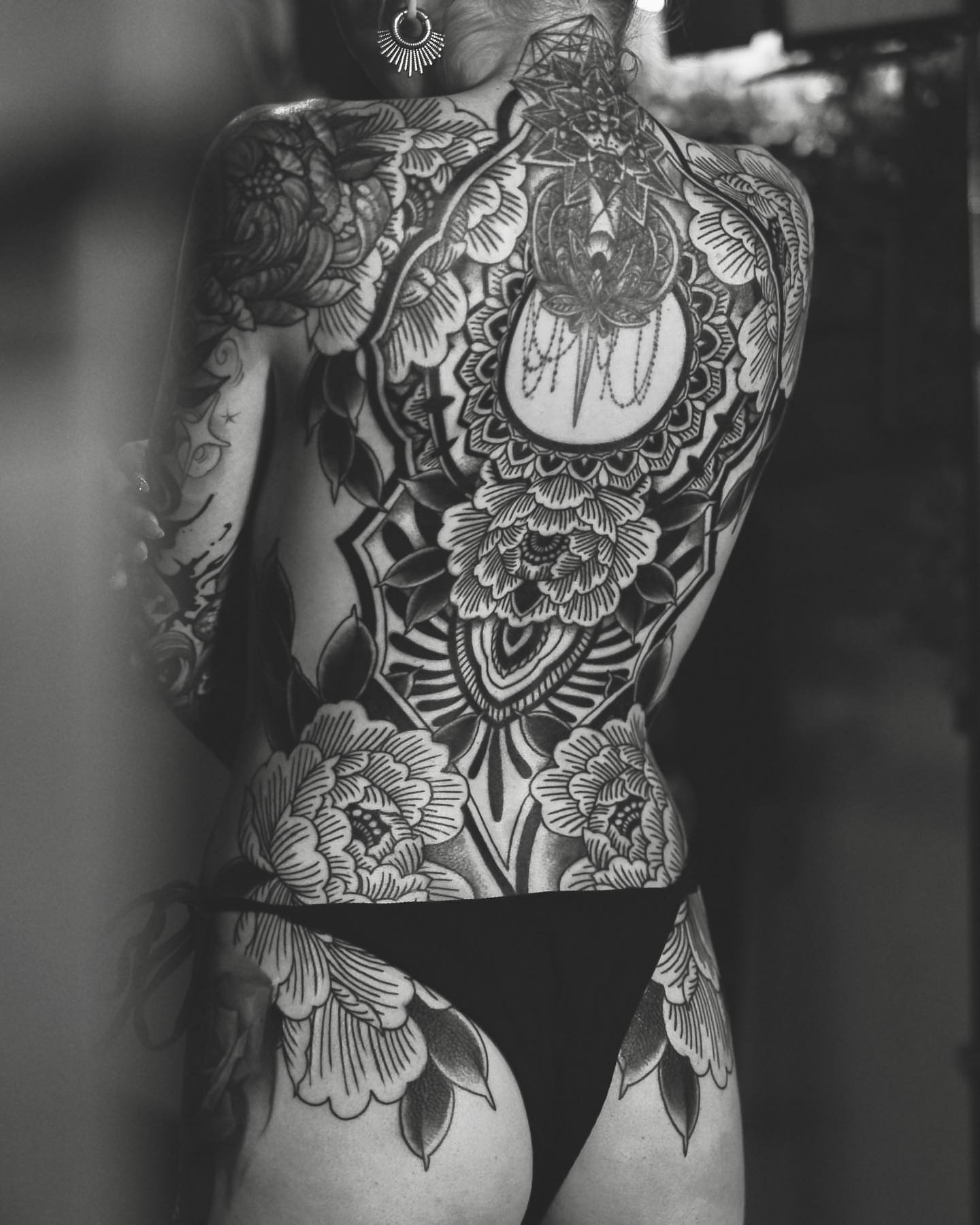 Floral mandala ornamental tattoo on the back by Nick Fierro