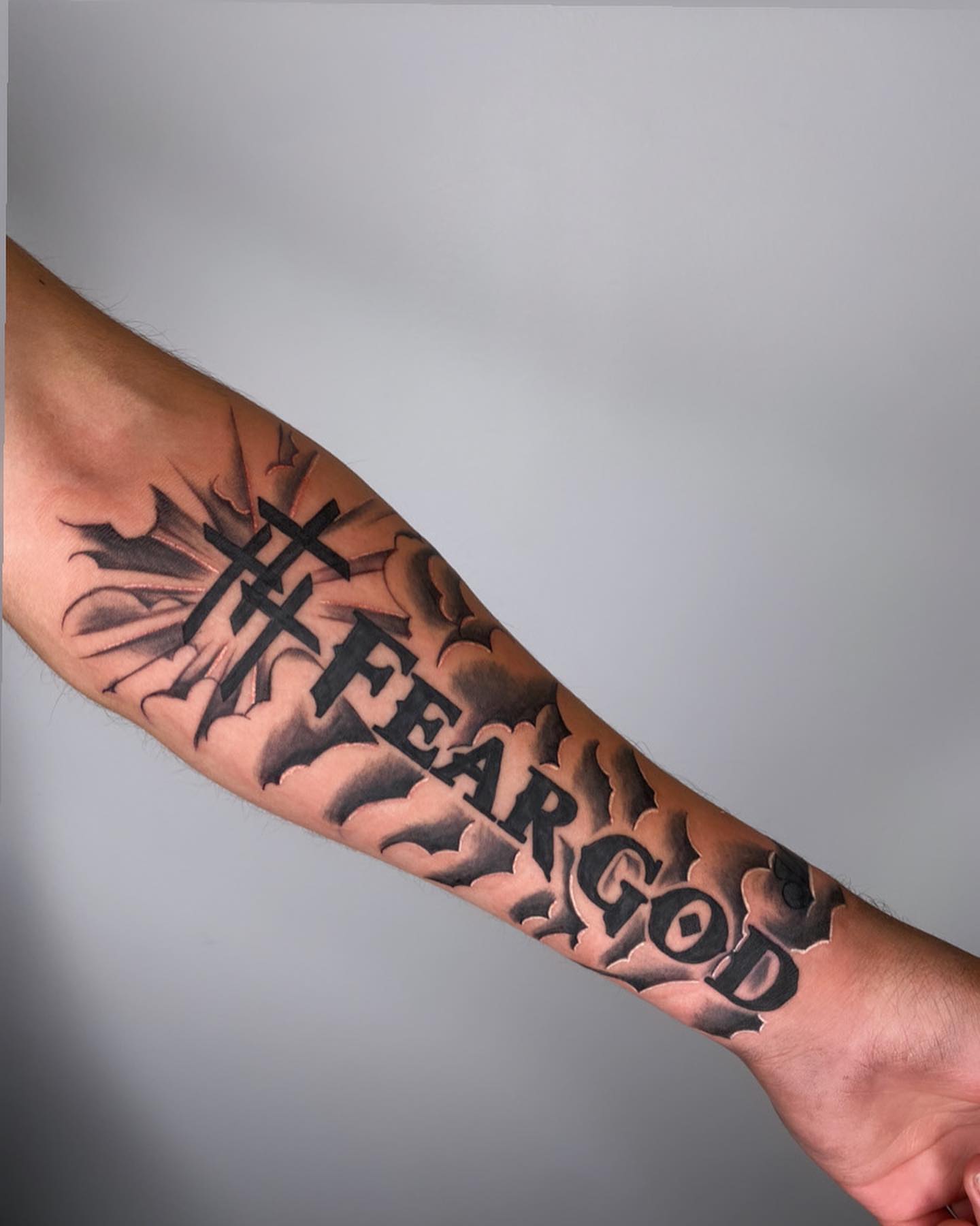 Fear god black and grey tattoo on the forearm by ▪️JhonnyElias TATTOO ▪️