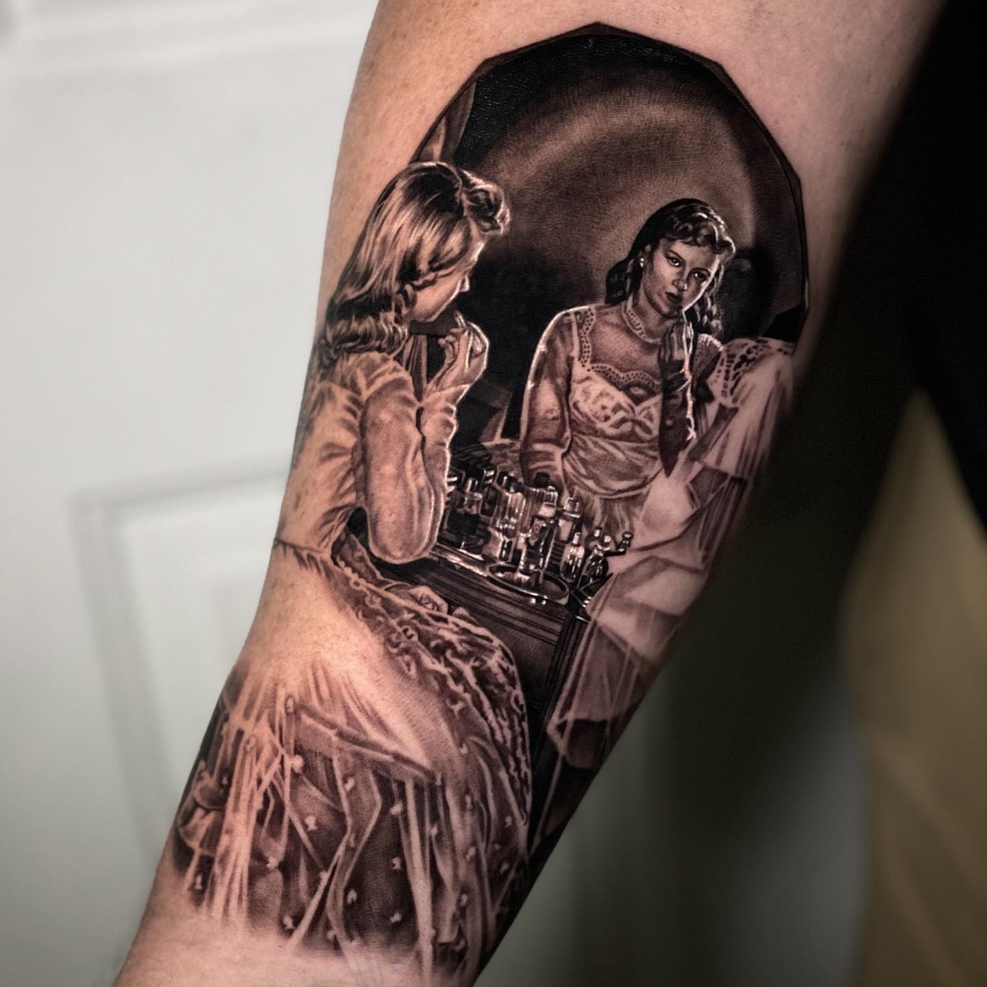 Woman at vanity realism tattoo on the forearm by Sergio Mendez