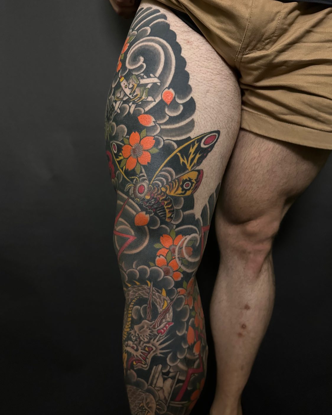 Butterfly and flowers American traditional tattoo on the thigh by Kenny Waizumi ๐