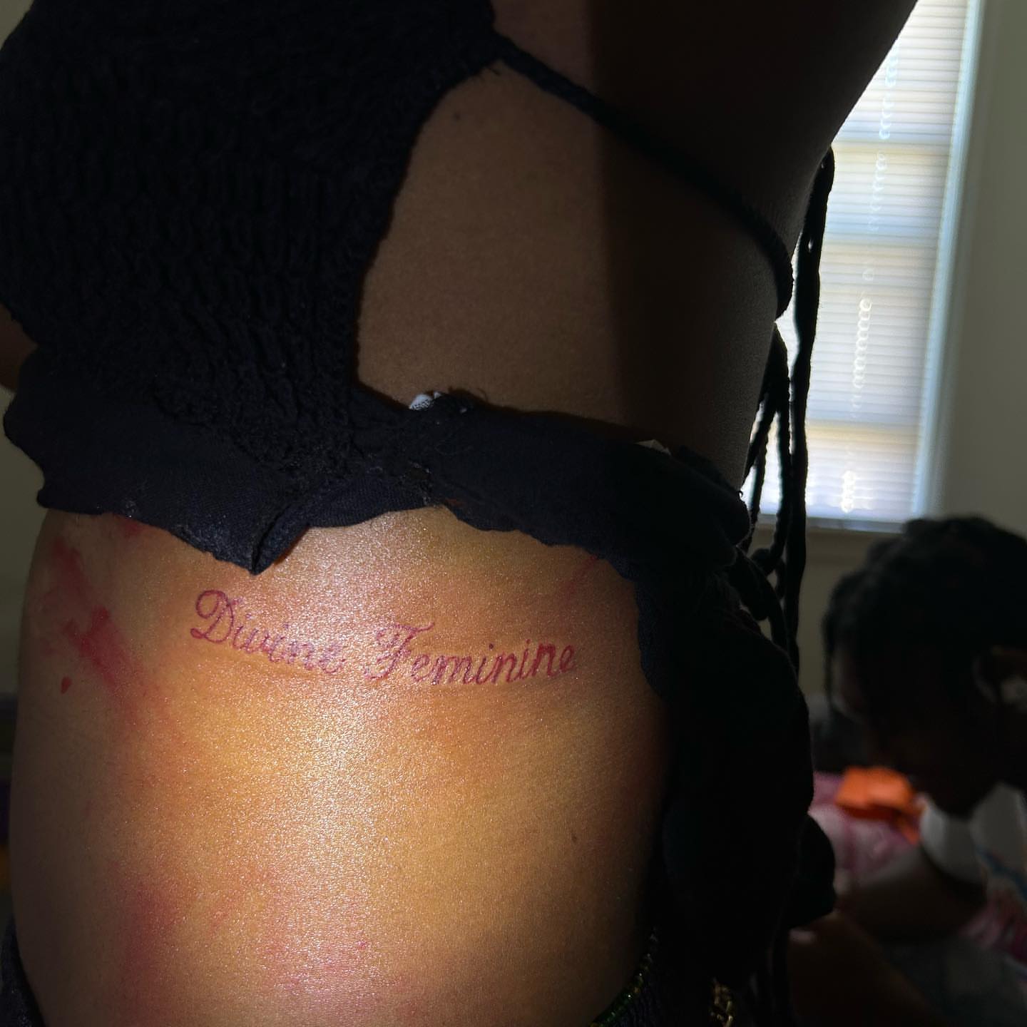 Divine feminine lettering script tattoo on the thigh by ๐ฆ