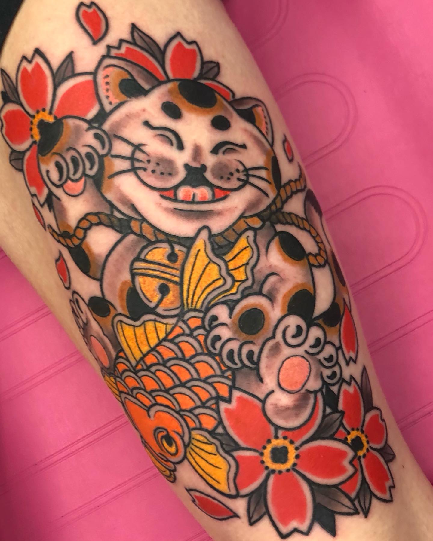 Lucky cat and koi fish American traditional tattoo on the thigh by Steven Campbell, Kansas City, Missouri