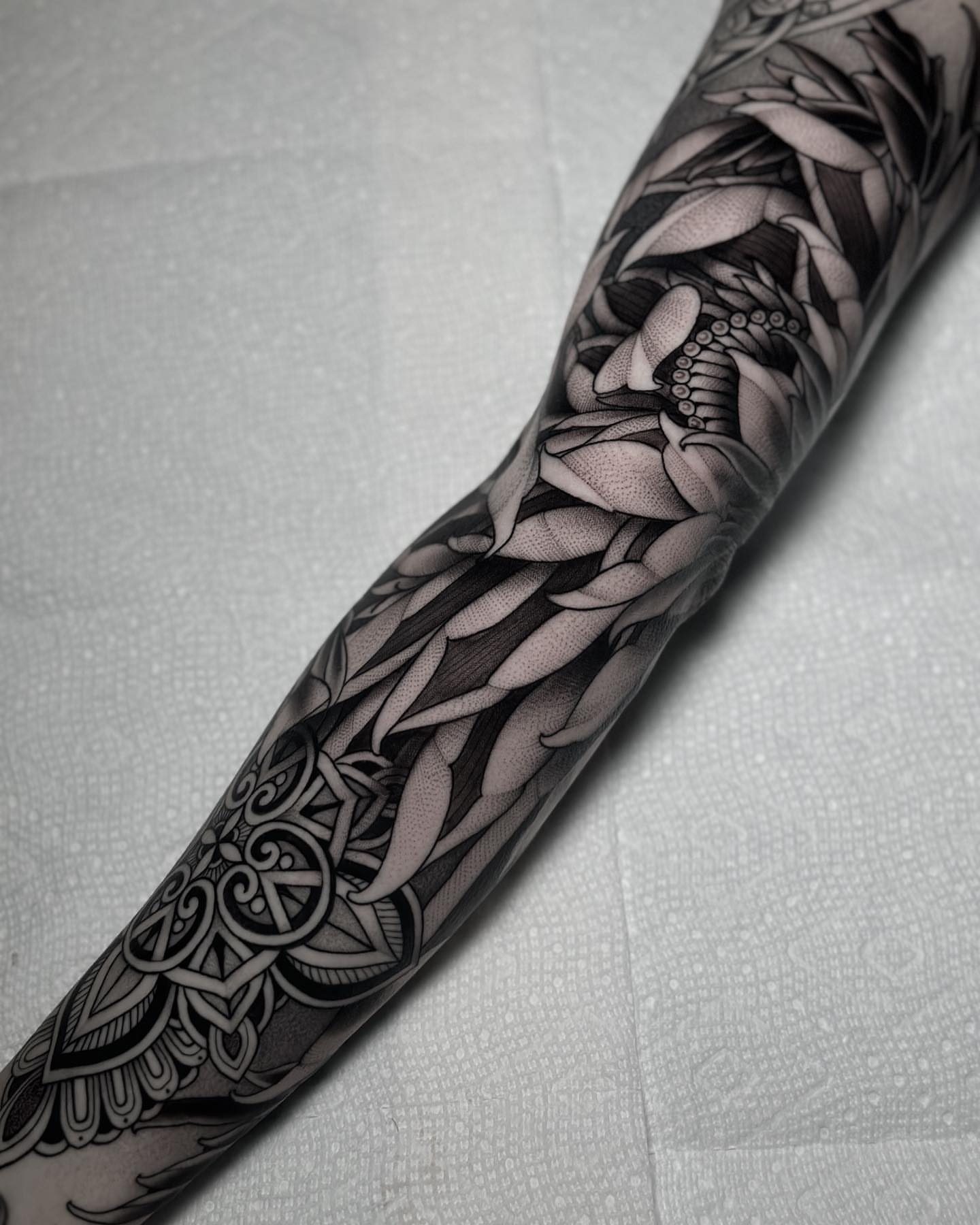 Lotus flower geometric tattoo on the forearm by San Diego