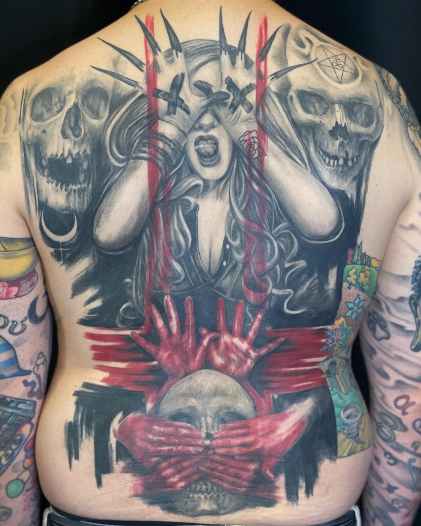 Woman with skulls dark realism tattoo on the back by Jacoba Kaufman
