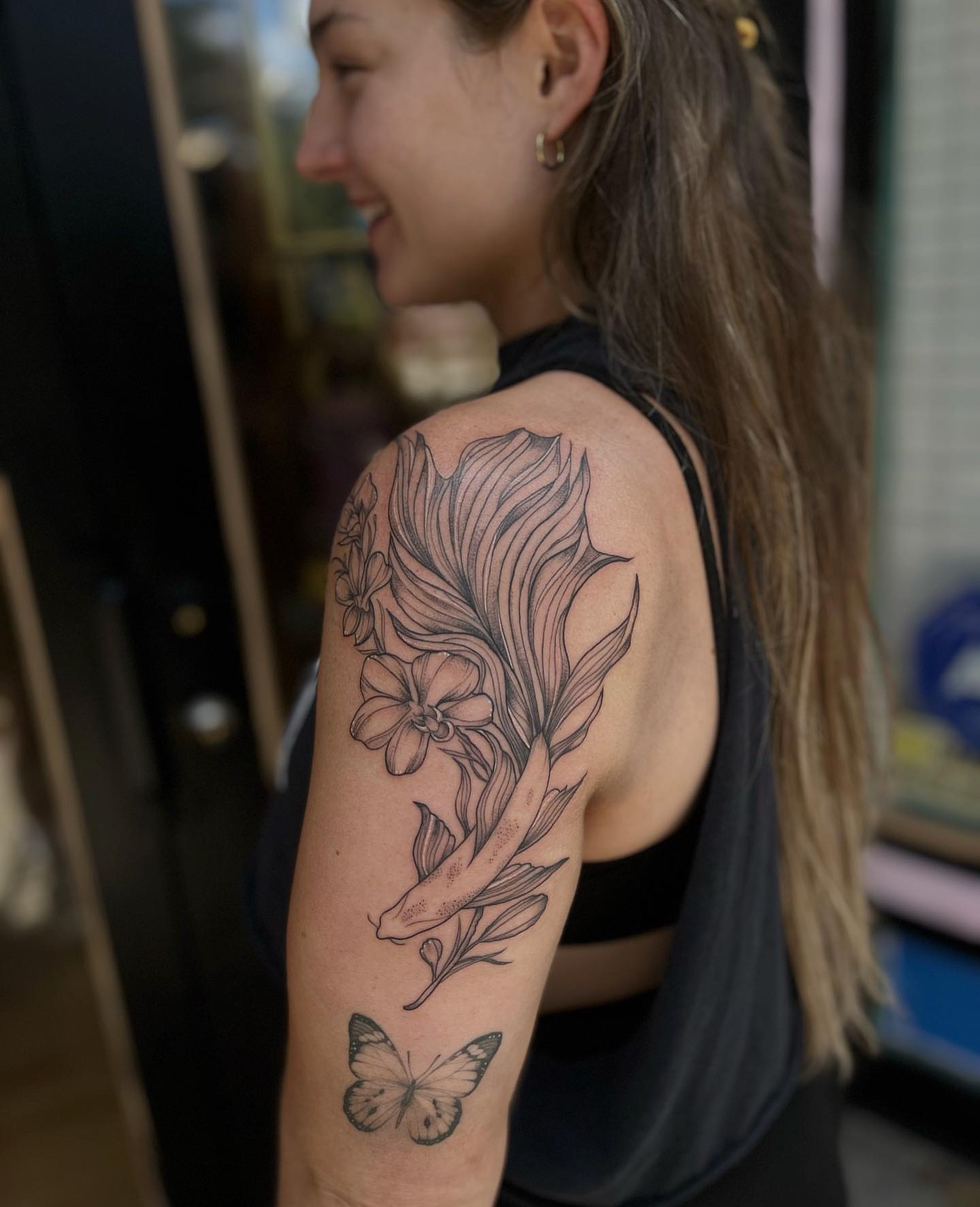 Flower and butterfly black and grey tattoo on the upper arm by ᥴꫝꪶꪮꫀ 𝘬ꪶꫀ𝓲ꪀ ❤️‍🔥, Denver, Colorado