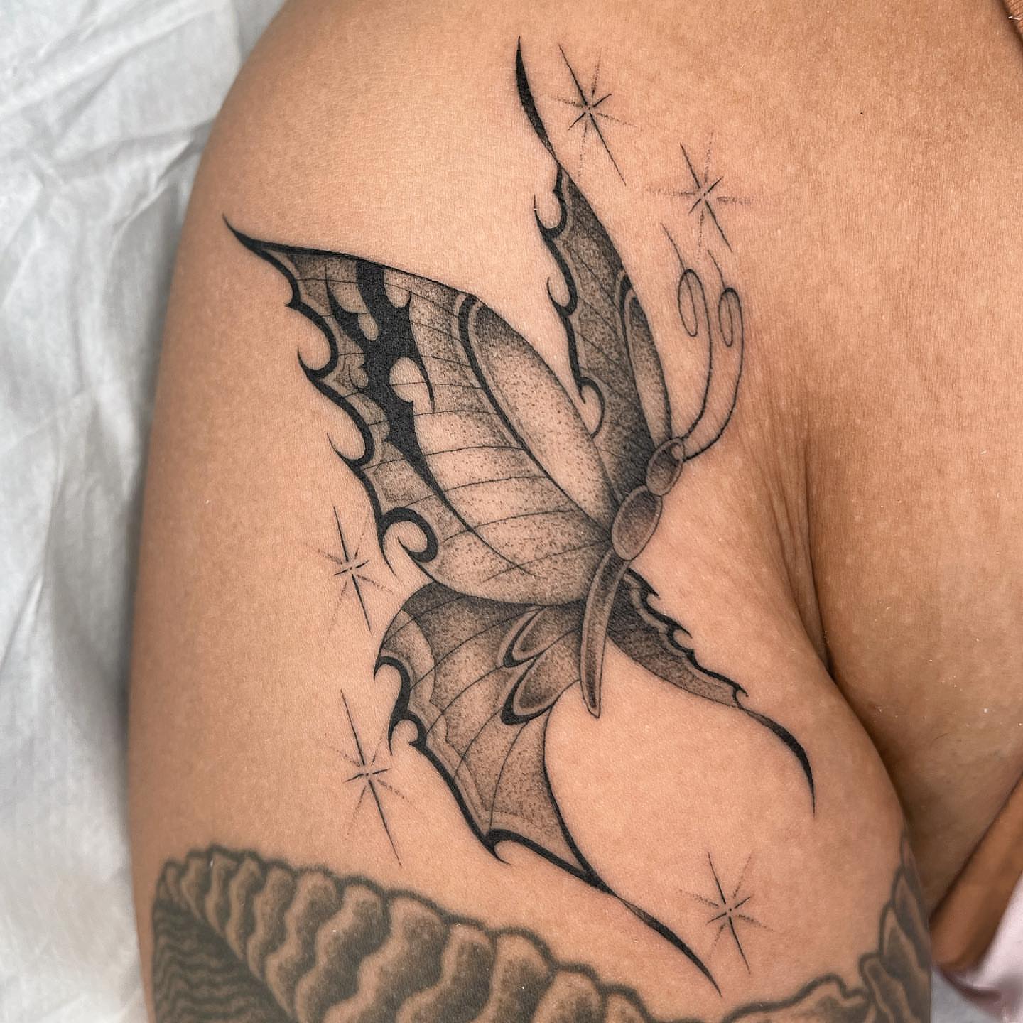 Butterfly black and grey tattoo on the thigh by Tiyanna Garlic