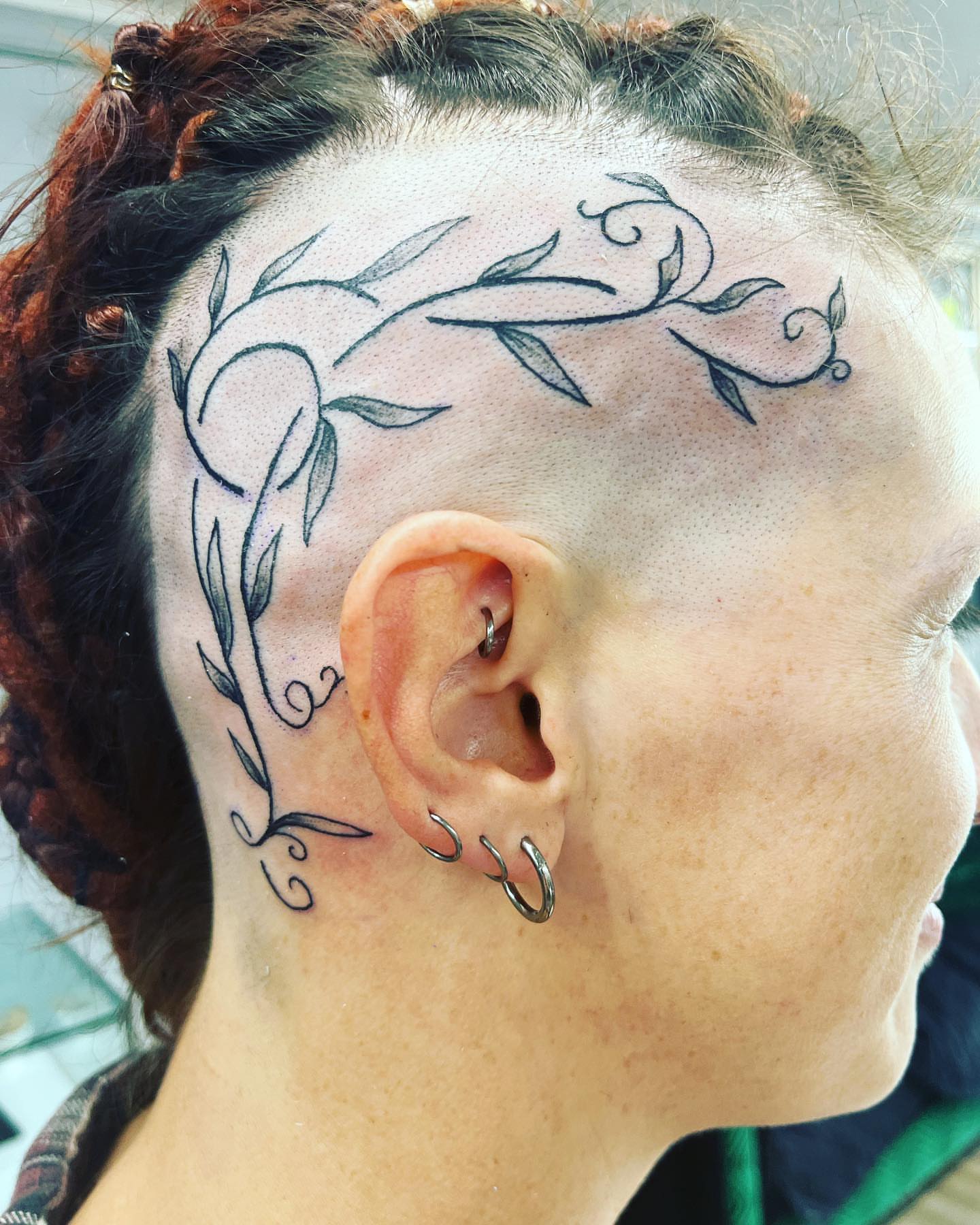Vine ornamental tattoo on the head by Frankie Sodapop Plumley