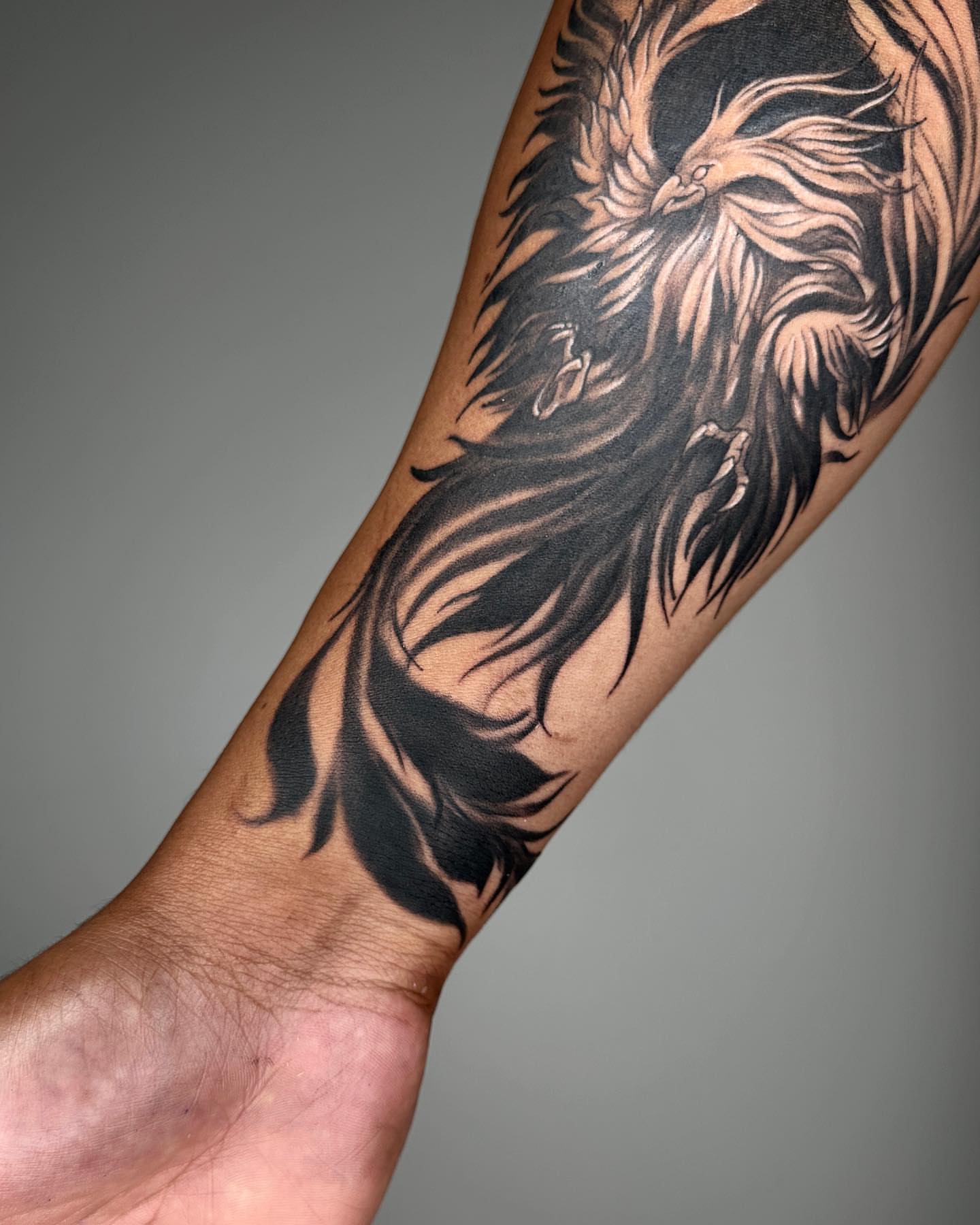 Phoenix black and grey tattoo on the forearm by A L e X