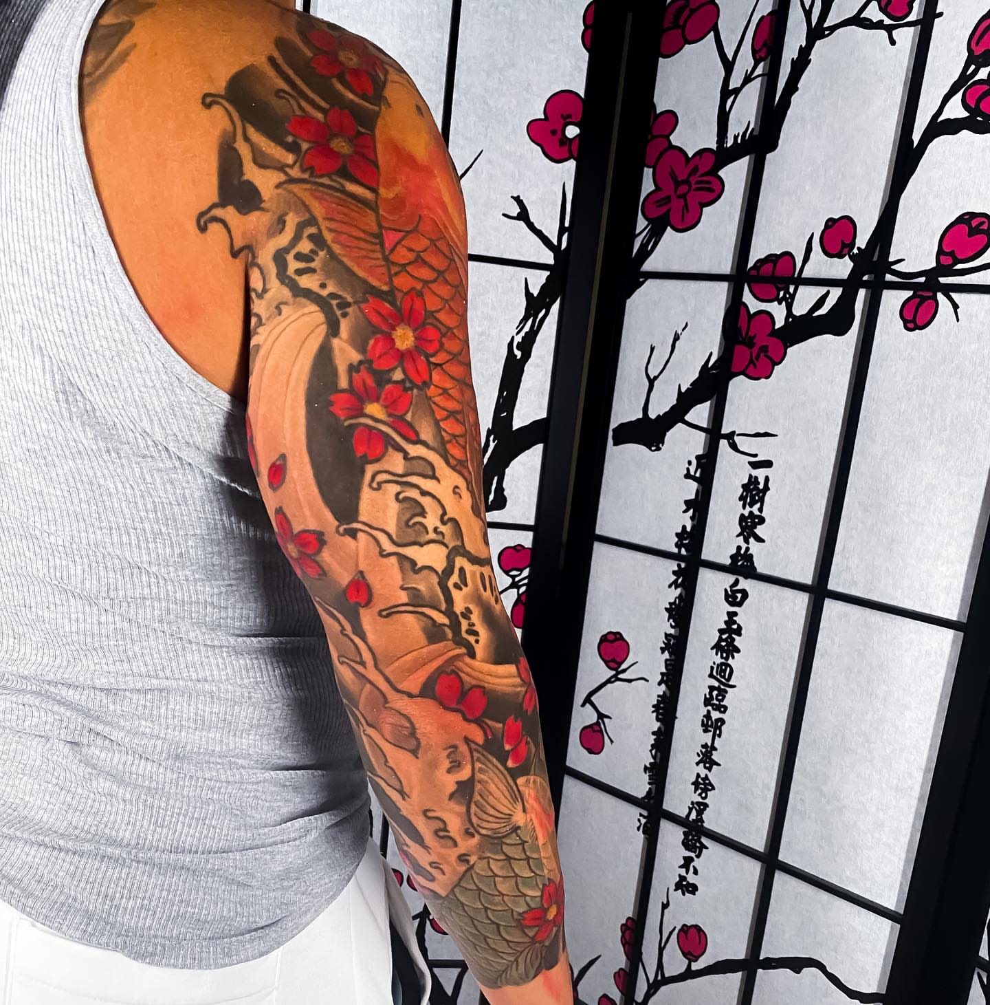 Koi fish and cherry blossoms japanese irezumi tattoo on the forearm by Eric James, Phoenix, Arizona
