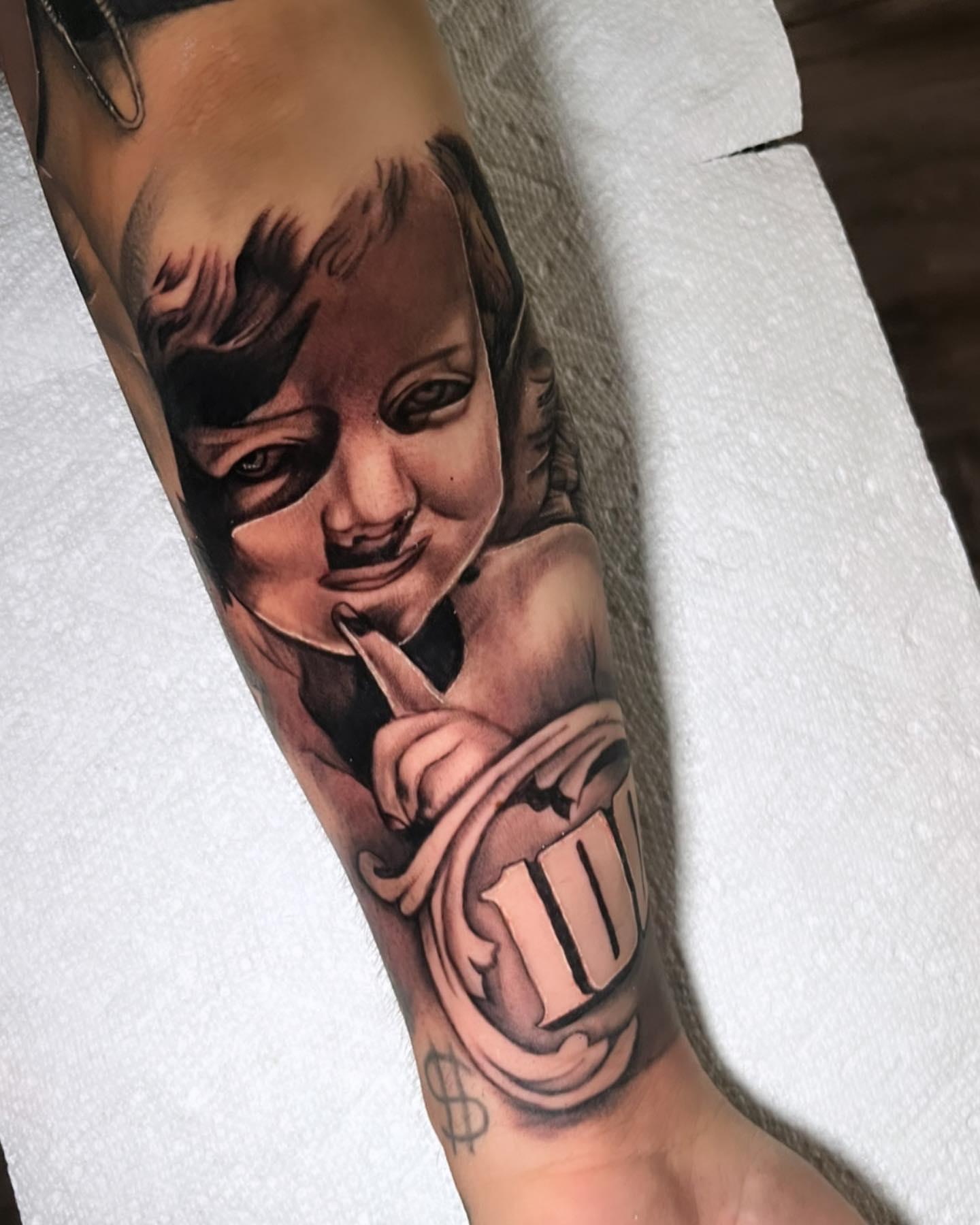Child with dollar sign realism tattoo on the forearm by ๐ธ๐๐๐.๐ฎ๐, Los Angeles, California