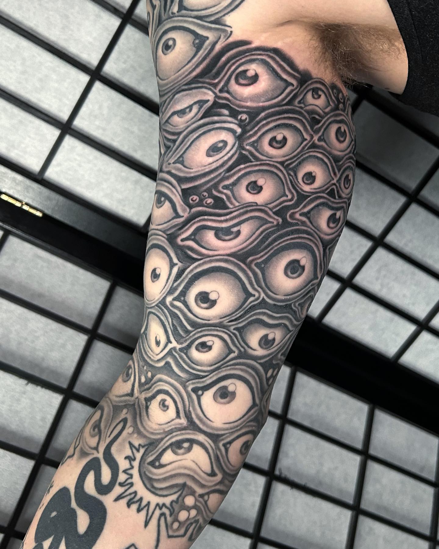 Eyes geometric tattoo on the forearm by Adam Mir