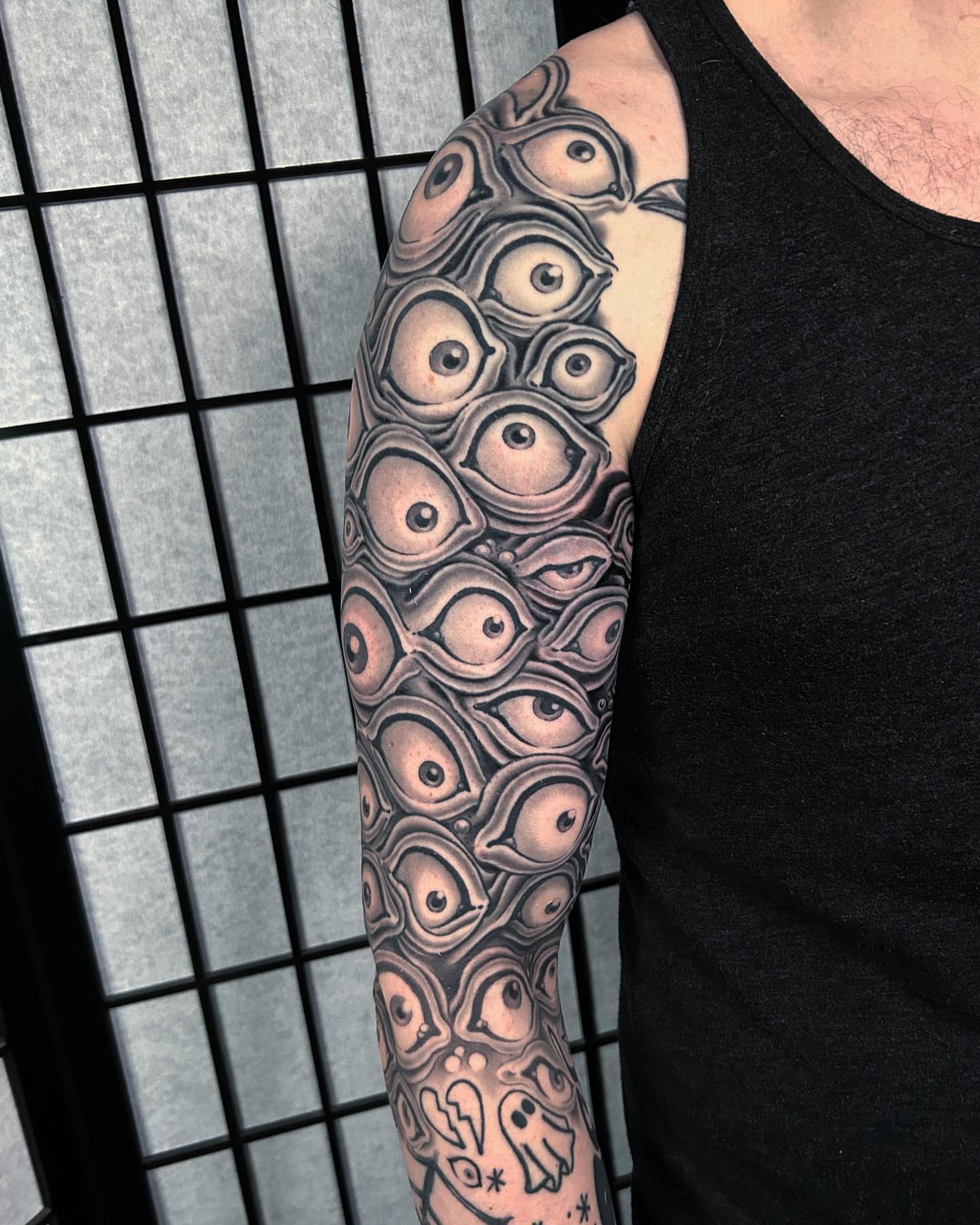 Eyes geometric tattoo on the forearm by Adam Mir
