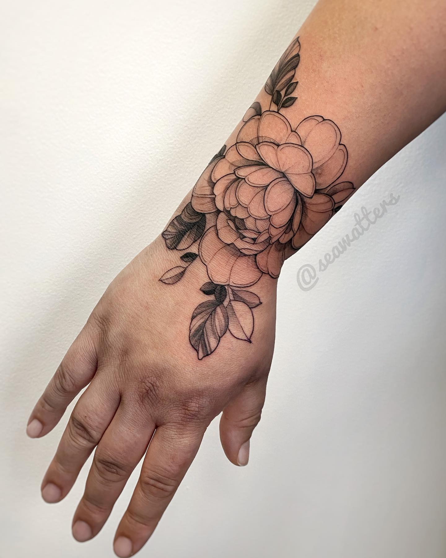 Flower black and grey tattoo on the forearm by Caitlin Watters