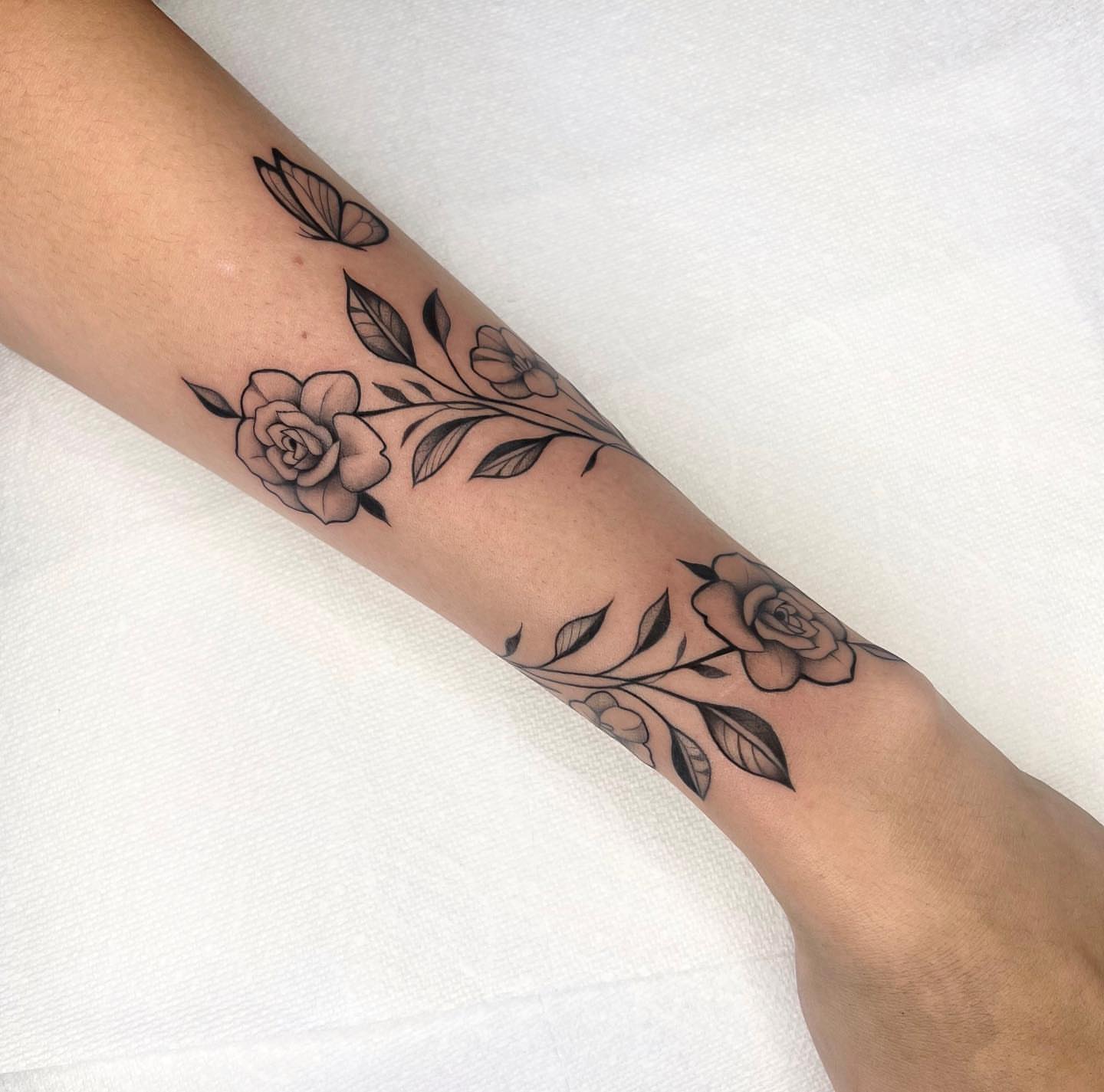 Flowers and leaves black and grey tattoo on the forearm by 🤎Dannon 🕸