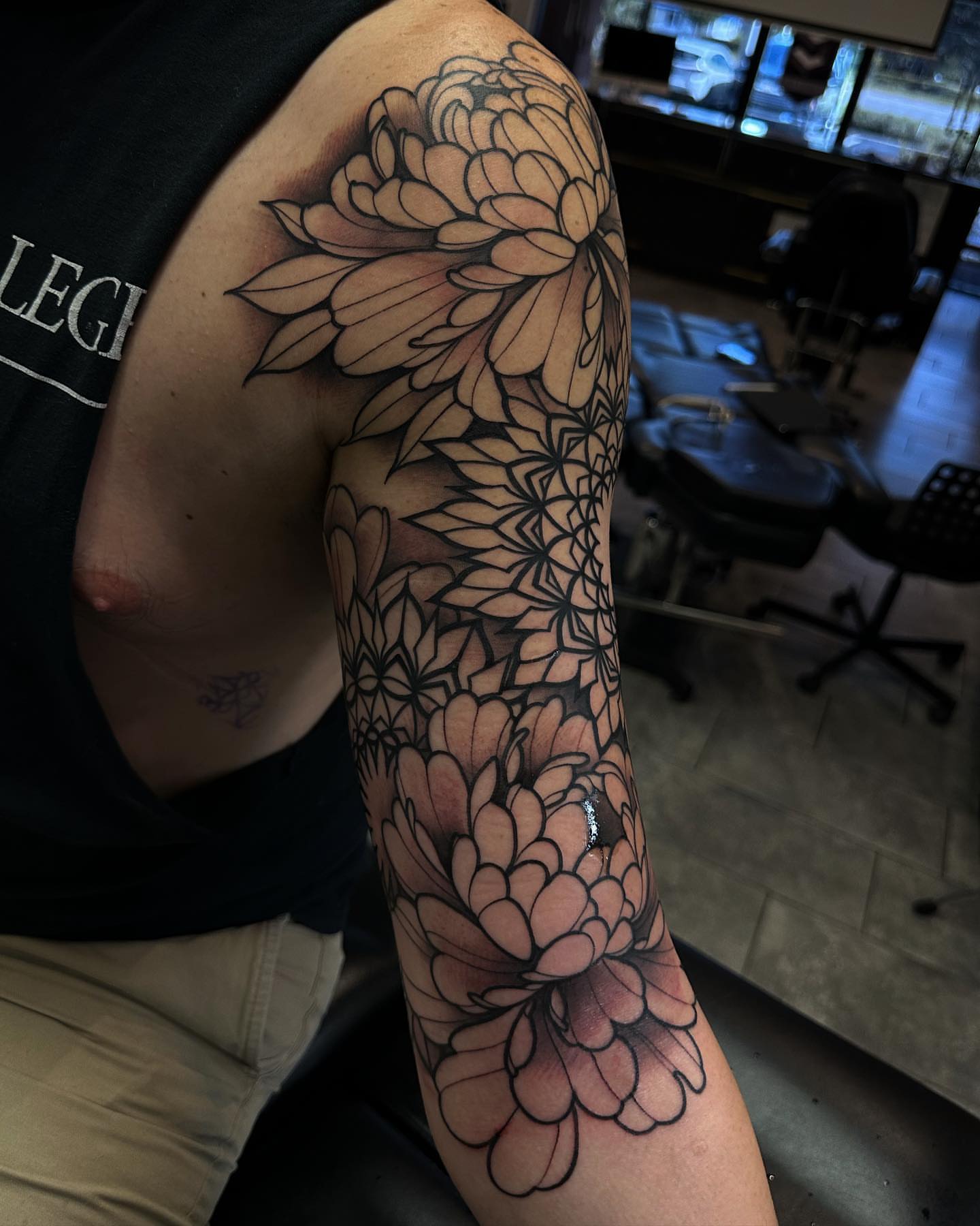 Chrysanthemum geometric tattoo on the forearm by Ryan K Severe