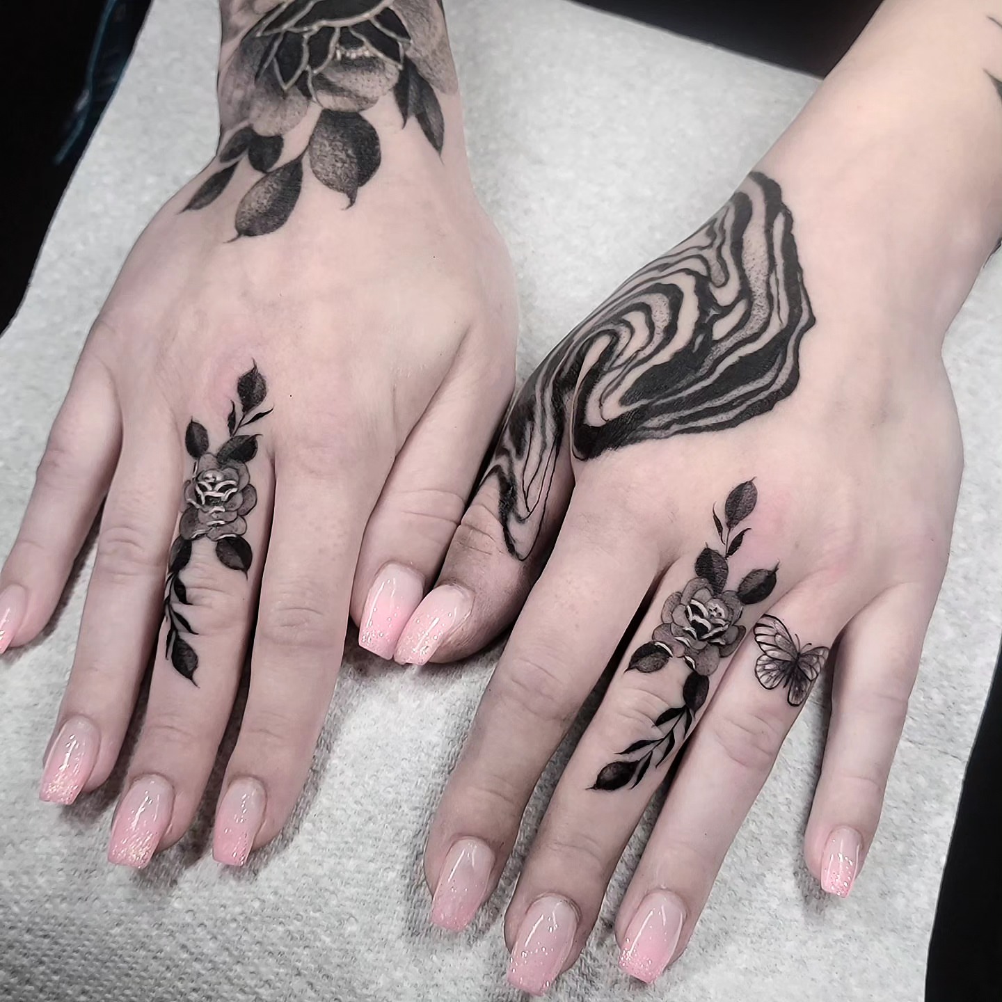 Floral and butterfly black and grey tattoo on the hand by miami tattoo artist