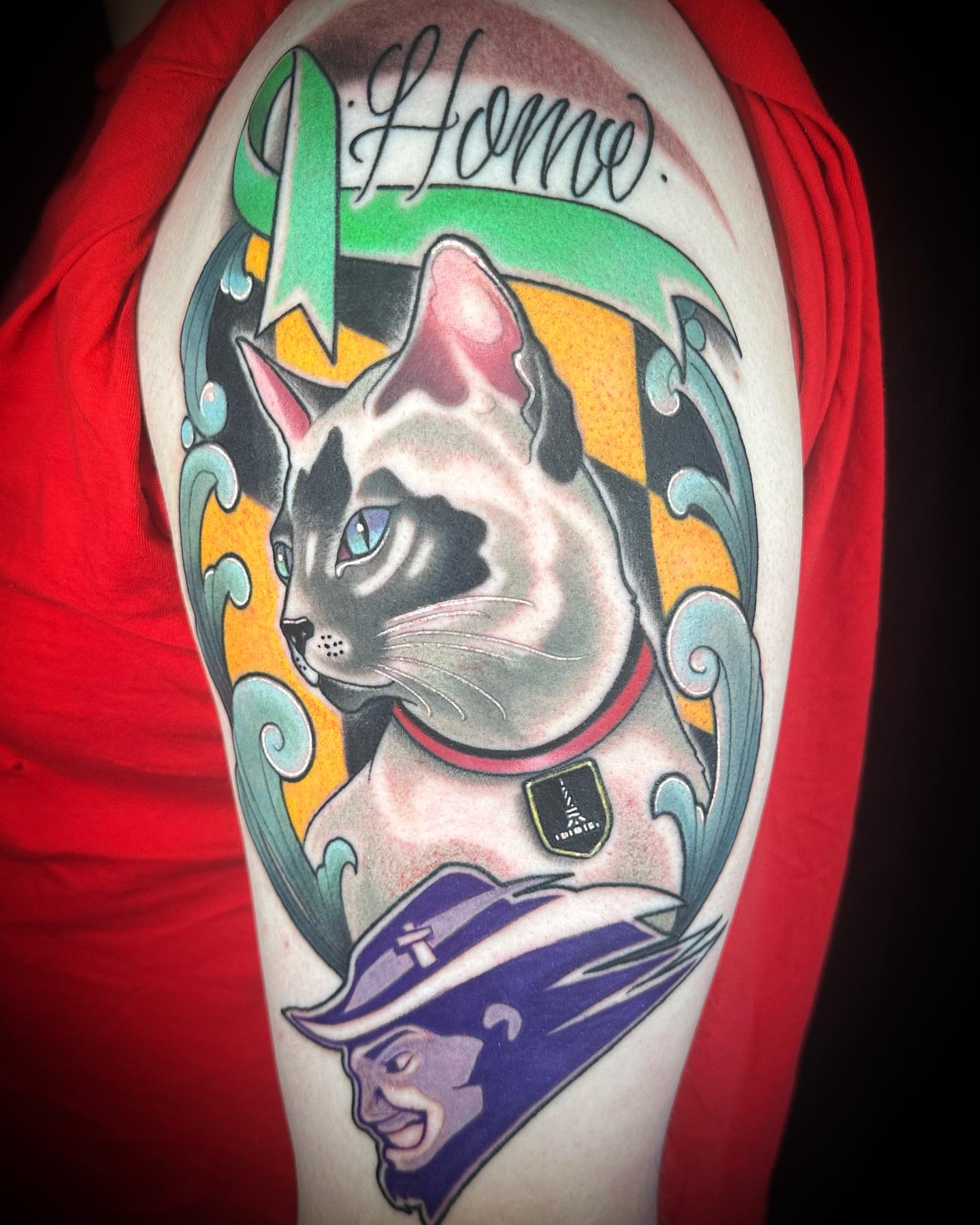 Cat and man American traditional tattoo on the upper arm by B.G. Germershausen