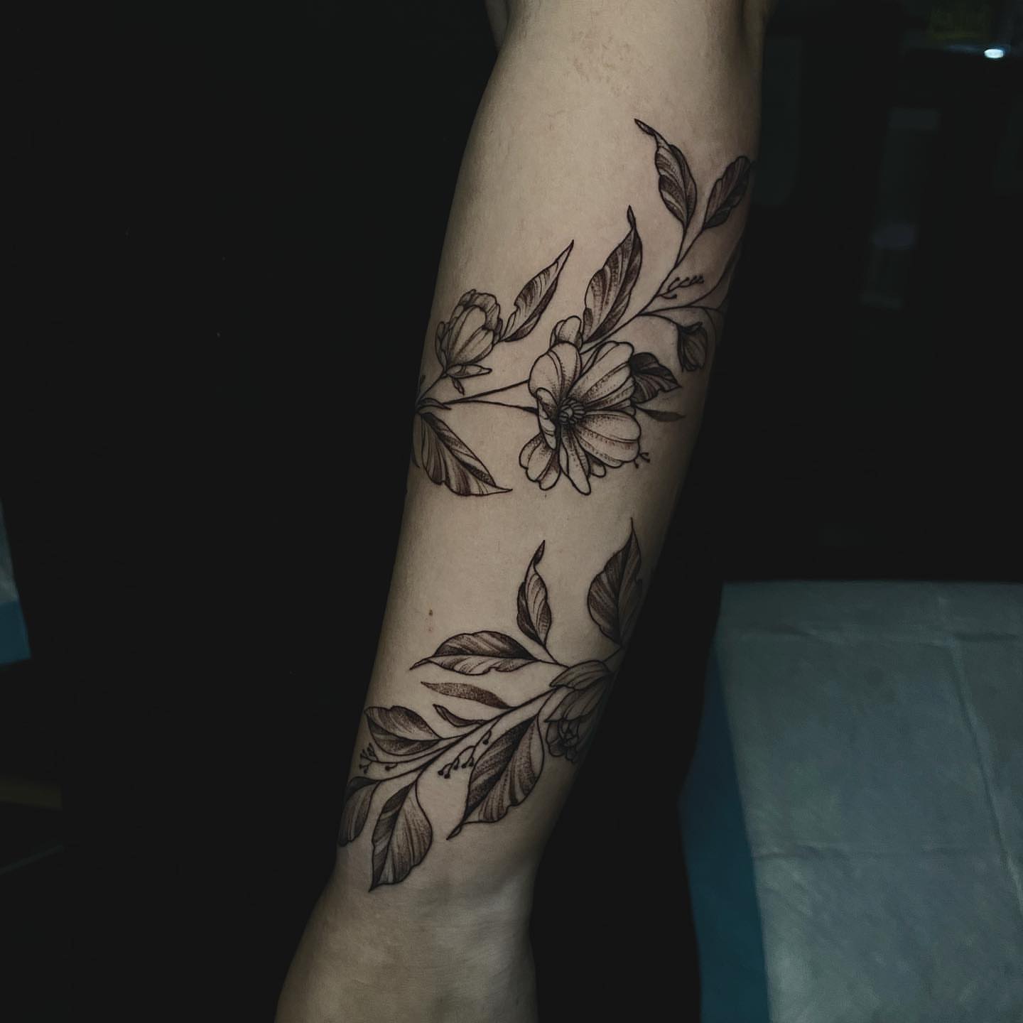 Floral bouquet black and grey tattoo on the forearm by Sydney Dixon, Sacramento, California