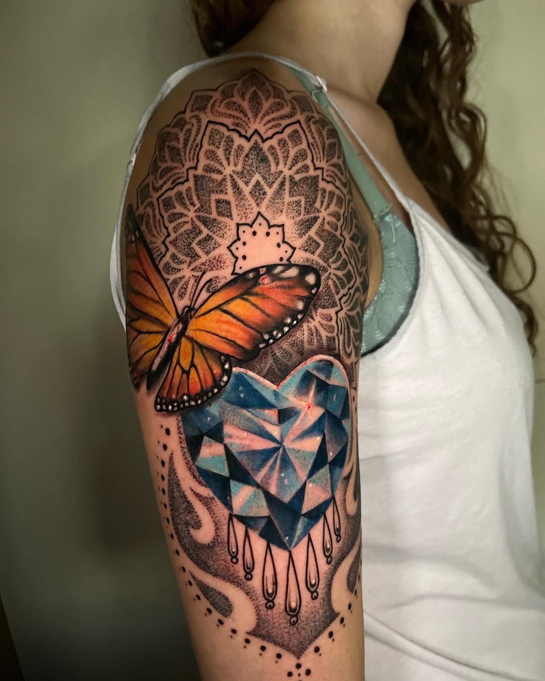 Butterfly and diamond heart geometric tattoo on the upper arm by Teagan Rachel, Millcreek, Utah