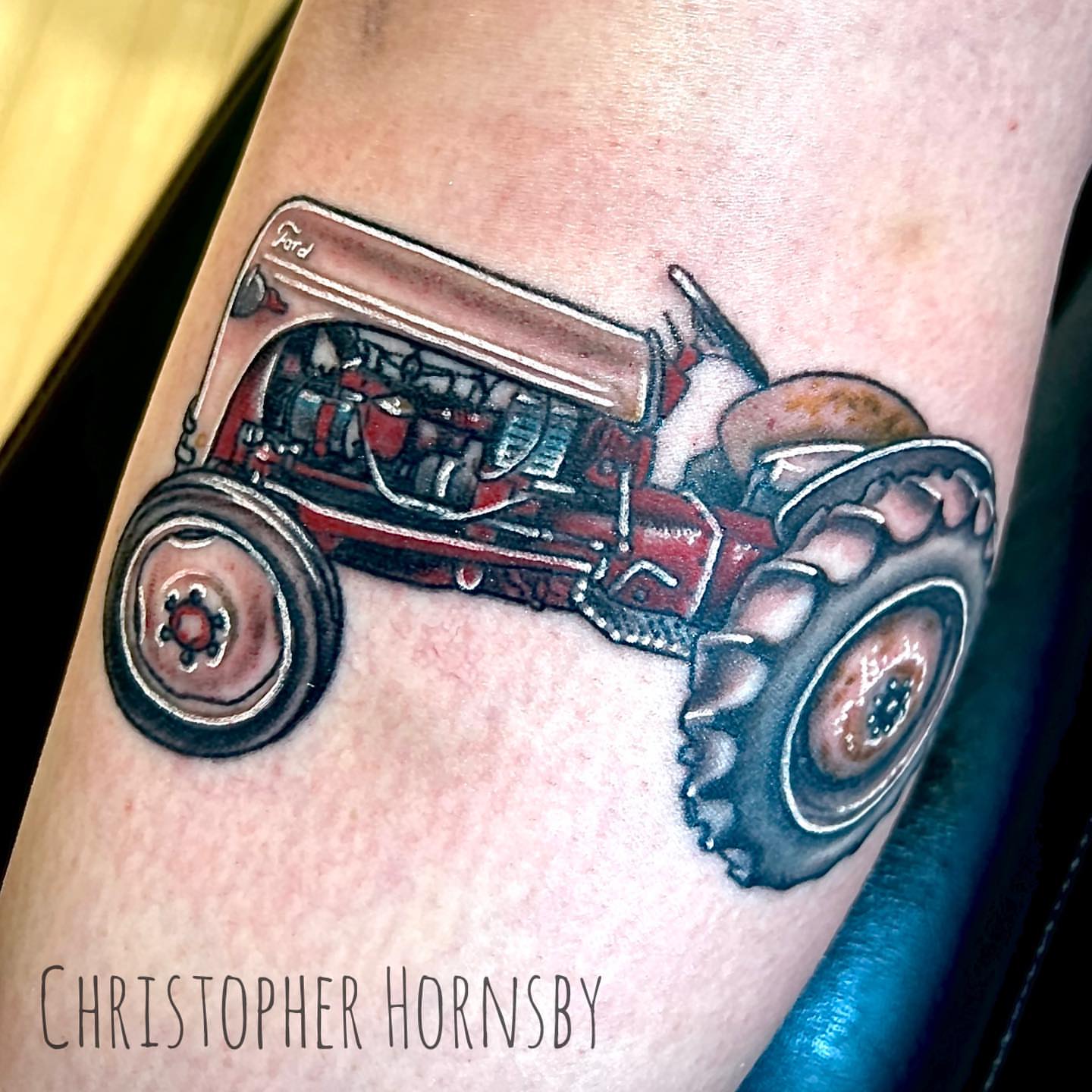 Tractor realism tattoo on the forearm by Chris Hornsby