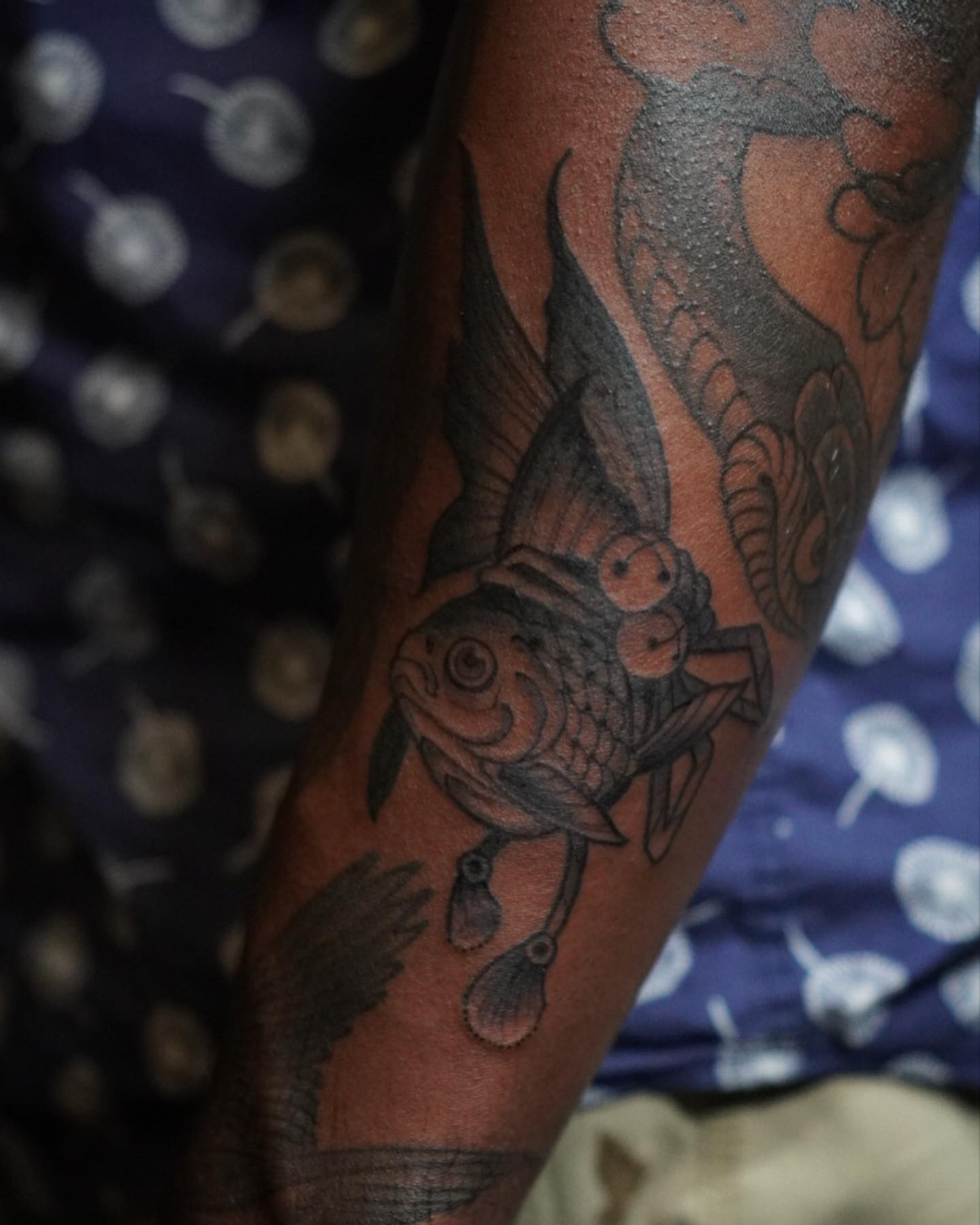 Fish black and grey tattoo on the forearm by Neo-Traditional tattoos in Las Vegas