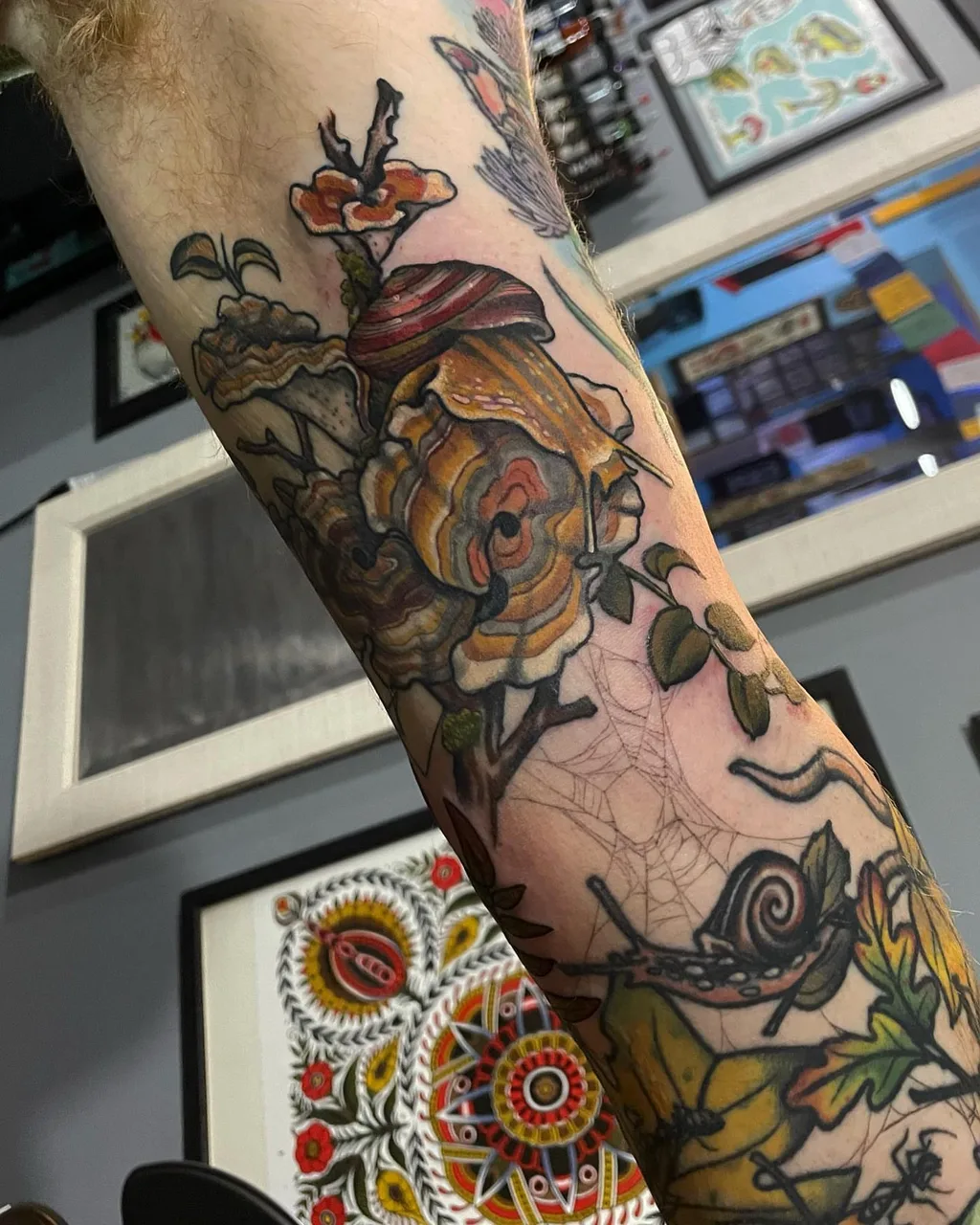 Snail and roses American traditional tattoo on the forearm by Lauren Vandevier