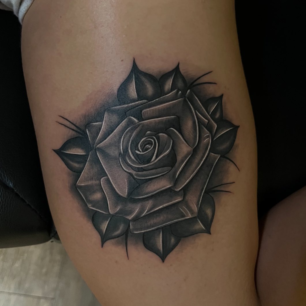 Rose black and grey tattoo on the thigh by Christopher McGlone