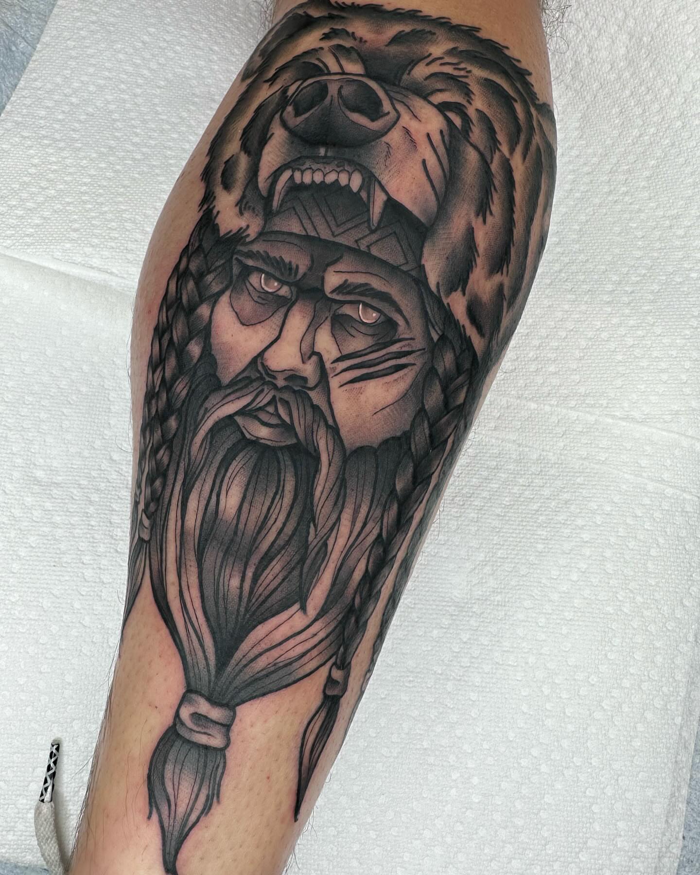 Bear and viking warrior realism tattoo on the forearm by Katie Kelley