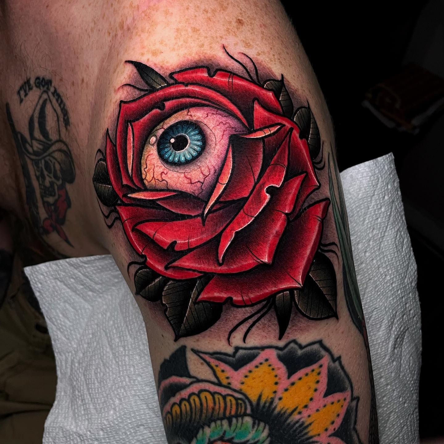 Eye within rose American traditional tattoo on the forearm by Ick Abrams