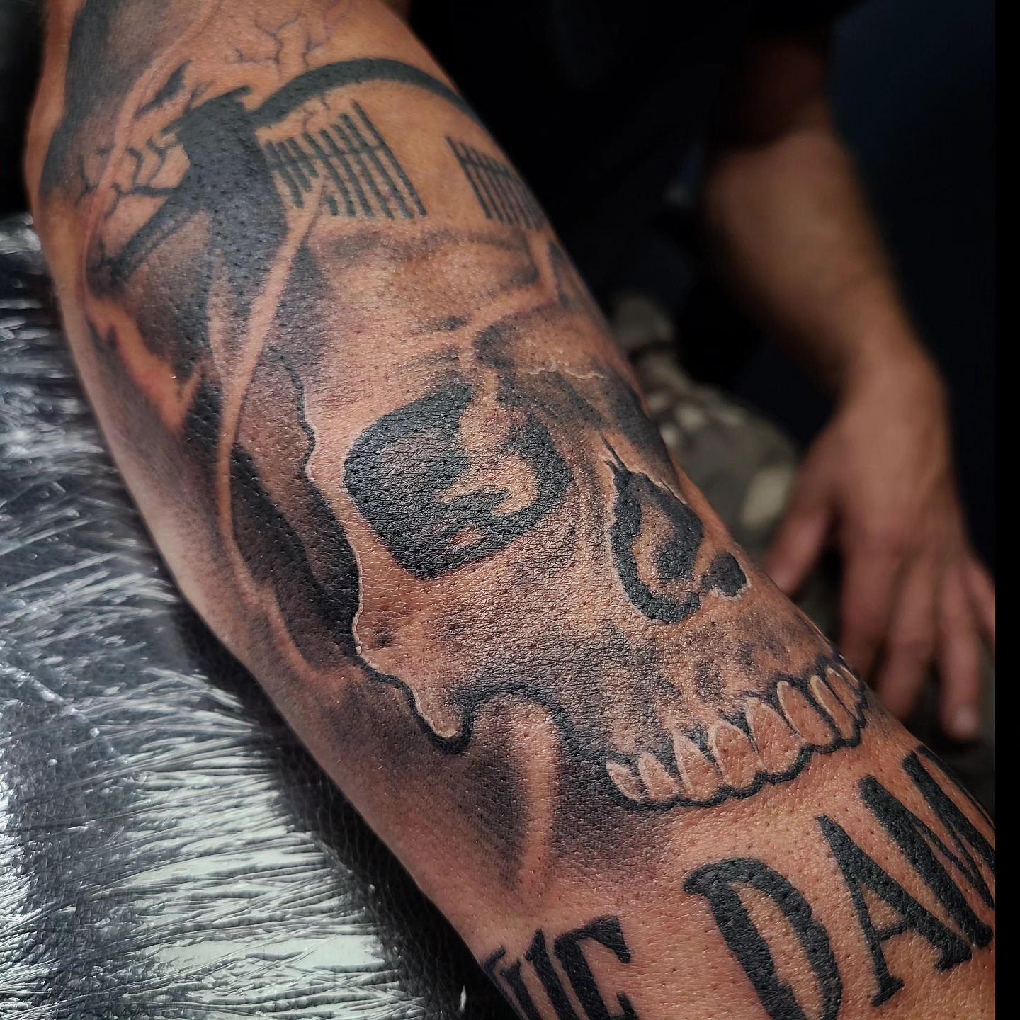 Skull black and grey tattoo on the forearm by David Johnson