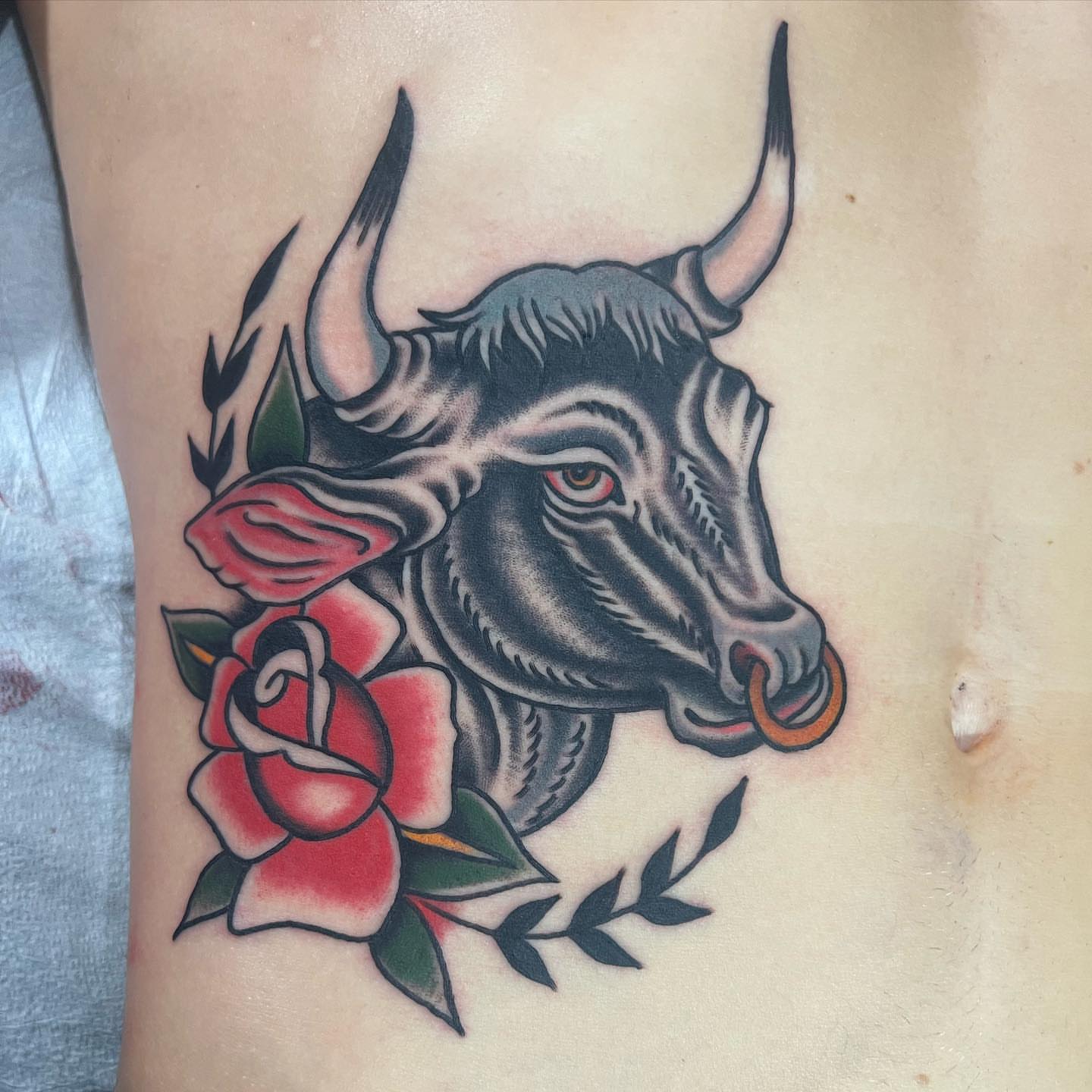 Bull and roses American traditional tattoo on the thigh by Ross K. Jones Tattoos, San Francisco, California