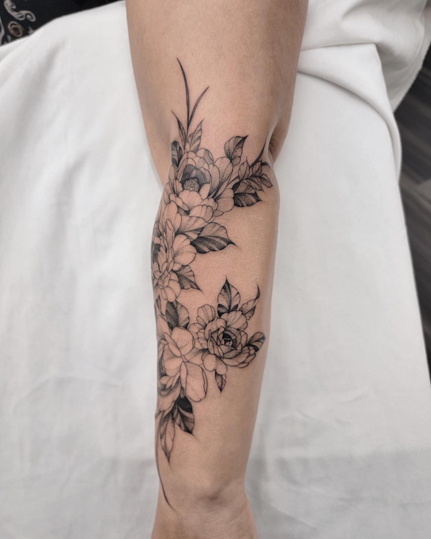 Floral bouquet black and grey tattoo on the forearm by Houston Tattoo Artist