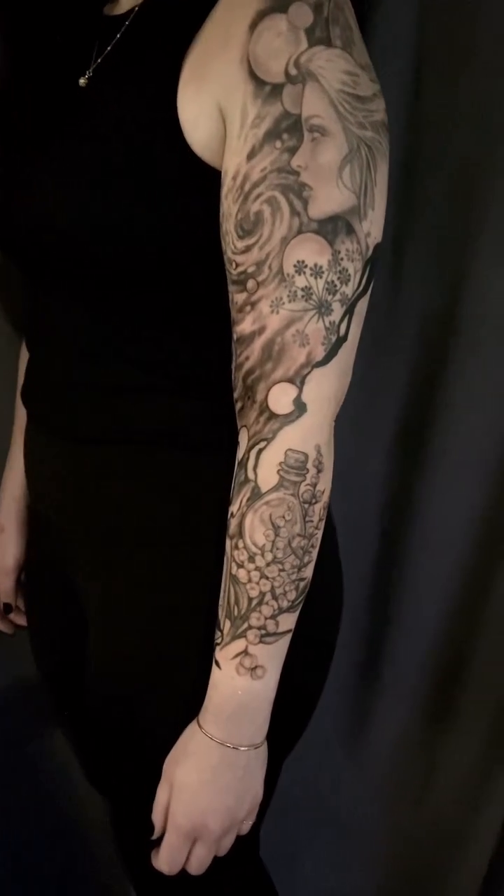 Realism tattoo on the upper arm by Dana Jones