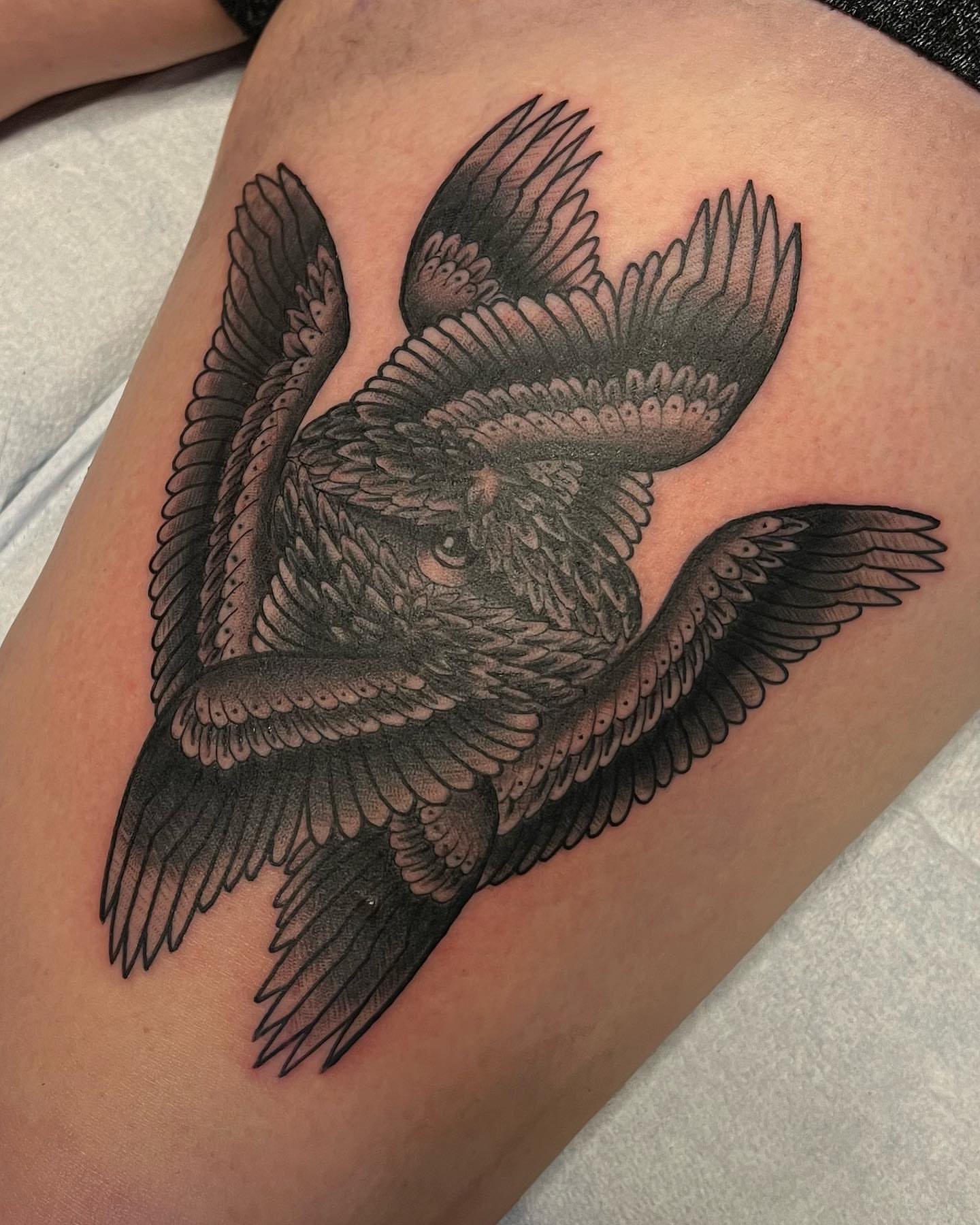 Bird black and grey tattoo on the thigh by Daniel Patrick
