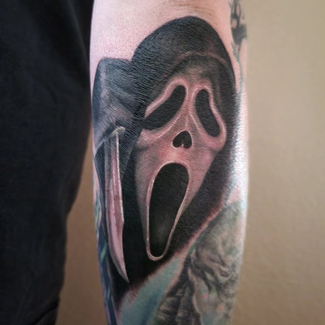 Ghostface mask from Scream realism tattoo on the forearm by Marina Cobb