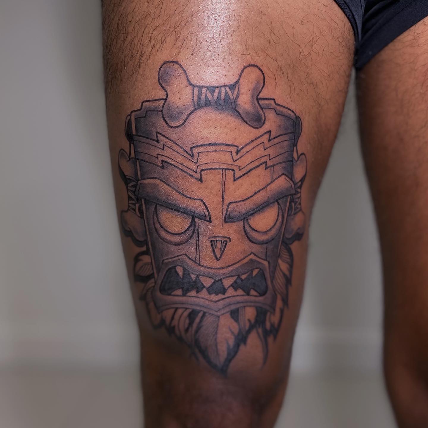 Mask black and grey tattoo on the thigh by Hailey K - Arizona Tattoo Artist, Miami, Florida