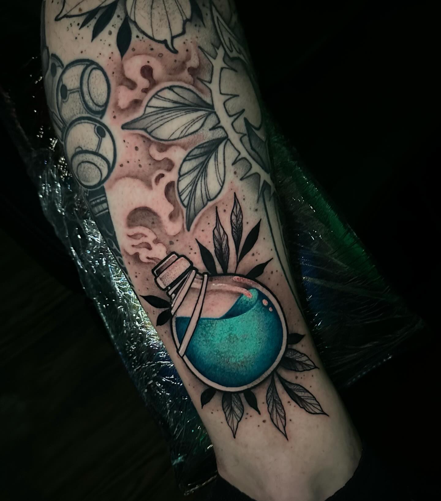 Bottle with glowing liquid dotwork tattoo on the forearm by Clayton Smith (BEAR)