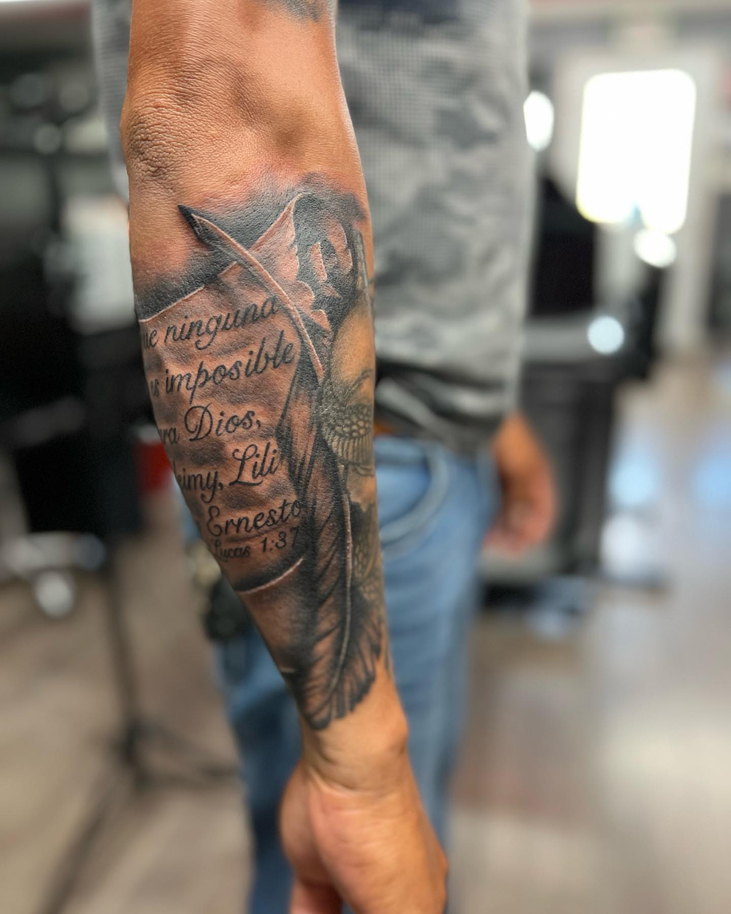 Angelic figure with cross black and grey tattoo on the forearm by π΅ππππ πΏπππππ, Houston, Texas