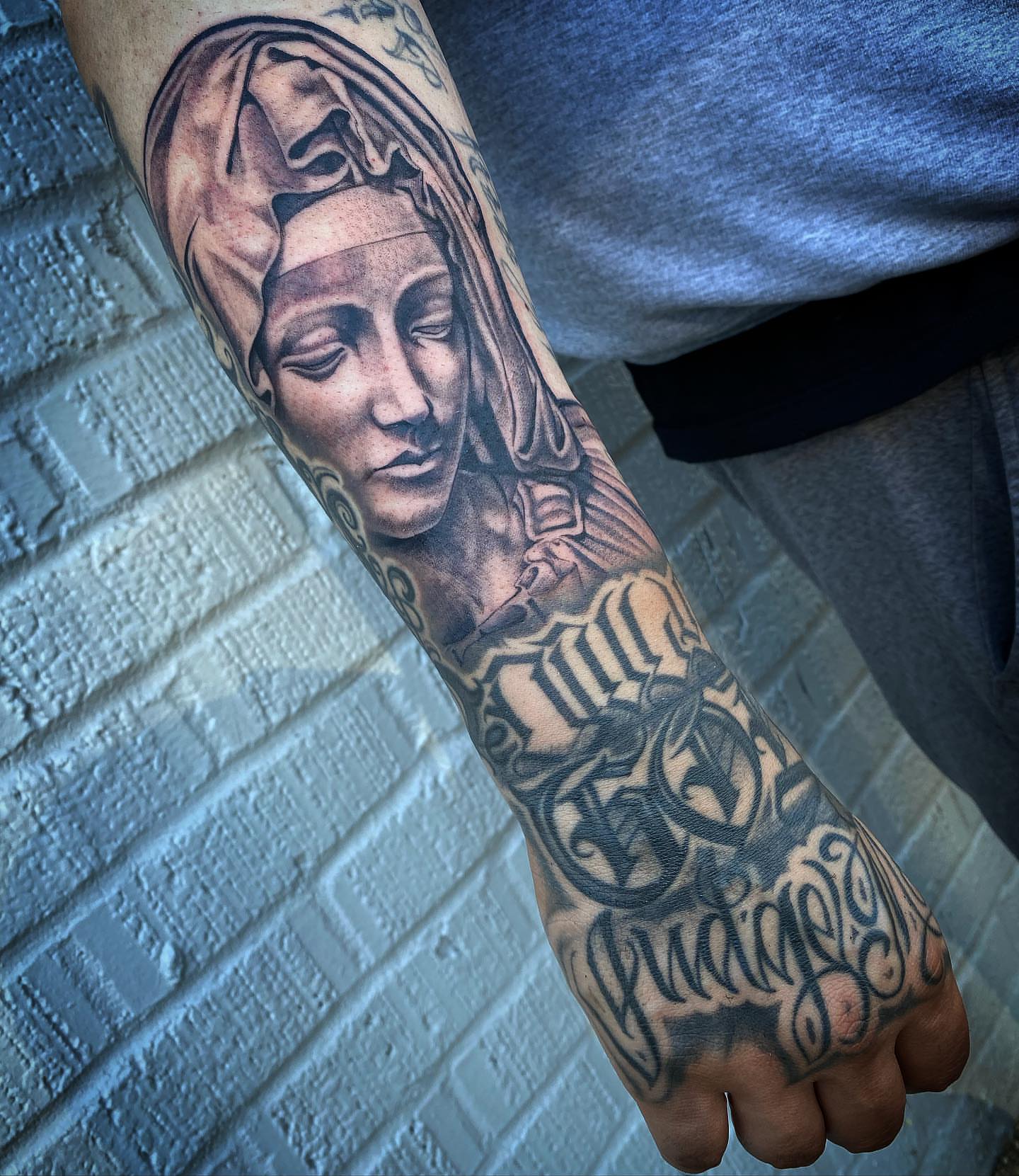 Religious figure realism tattoo on the forearm by El Pato, San Jose, California
