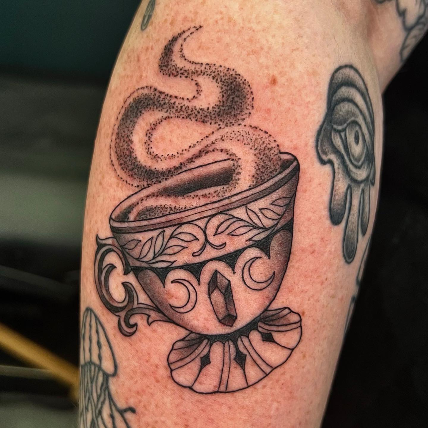 Coffee cup with steam dotwork tattoo on the forearm by Nikki Malfitano